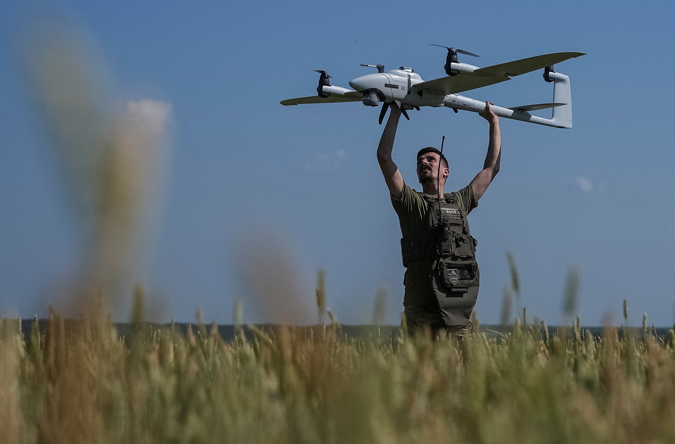A Ukrainian serviceman launches a mid-range reconnaissance type drone, Vector, for flying over positions of Russian troops in a Kharkiv region