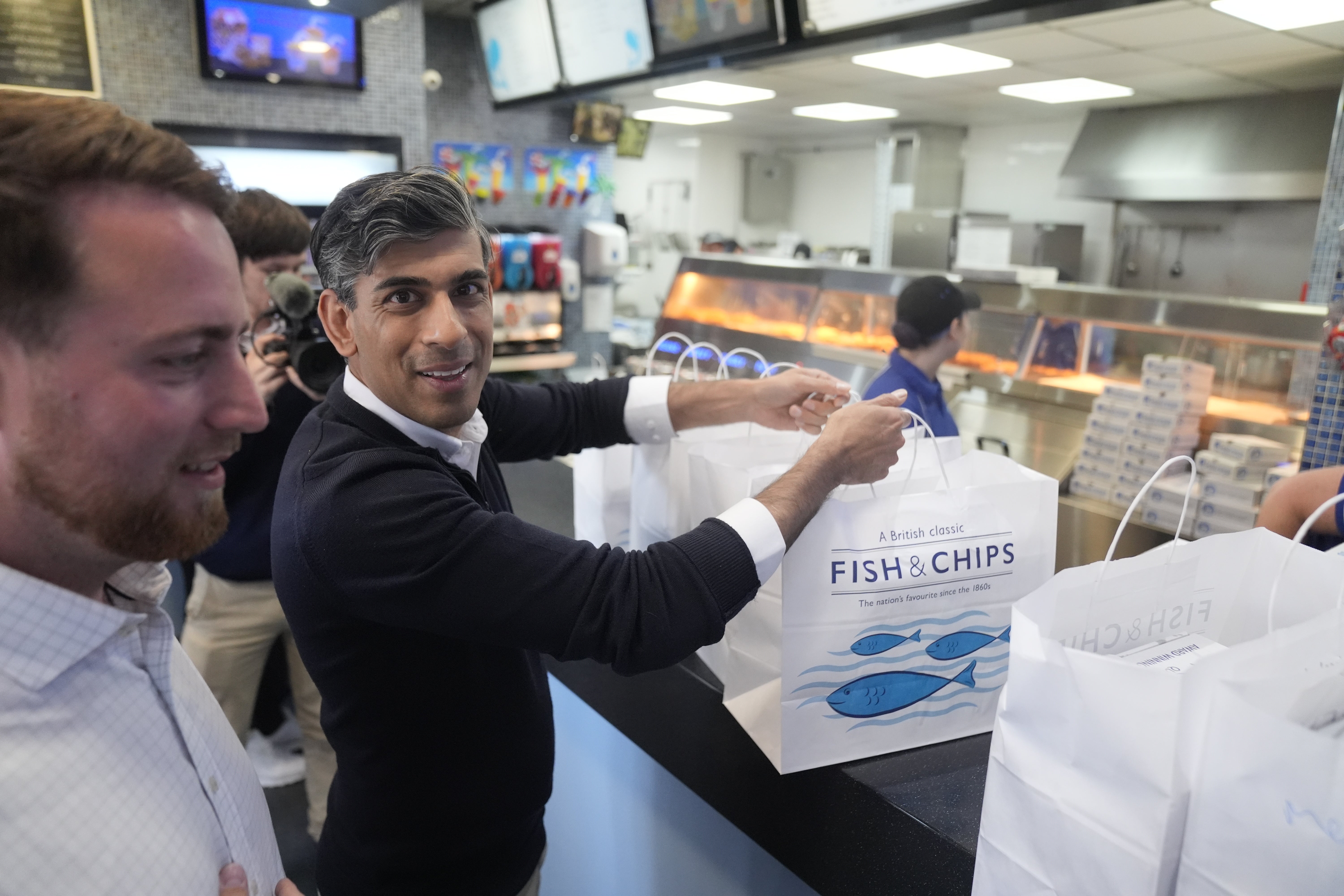 Rishi Sunak buys fish and chips for the media at the Sea Breeze fish and chips shop in Redcar, while on the campaign trail (Danny Lawson/PA)