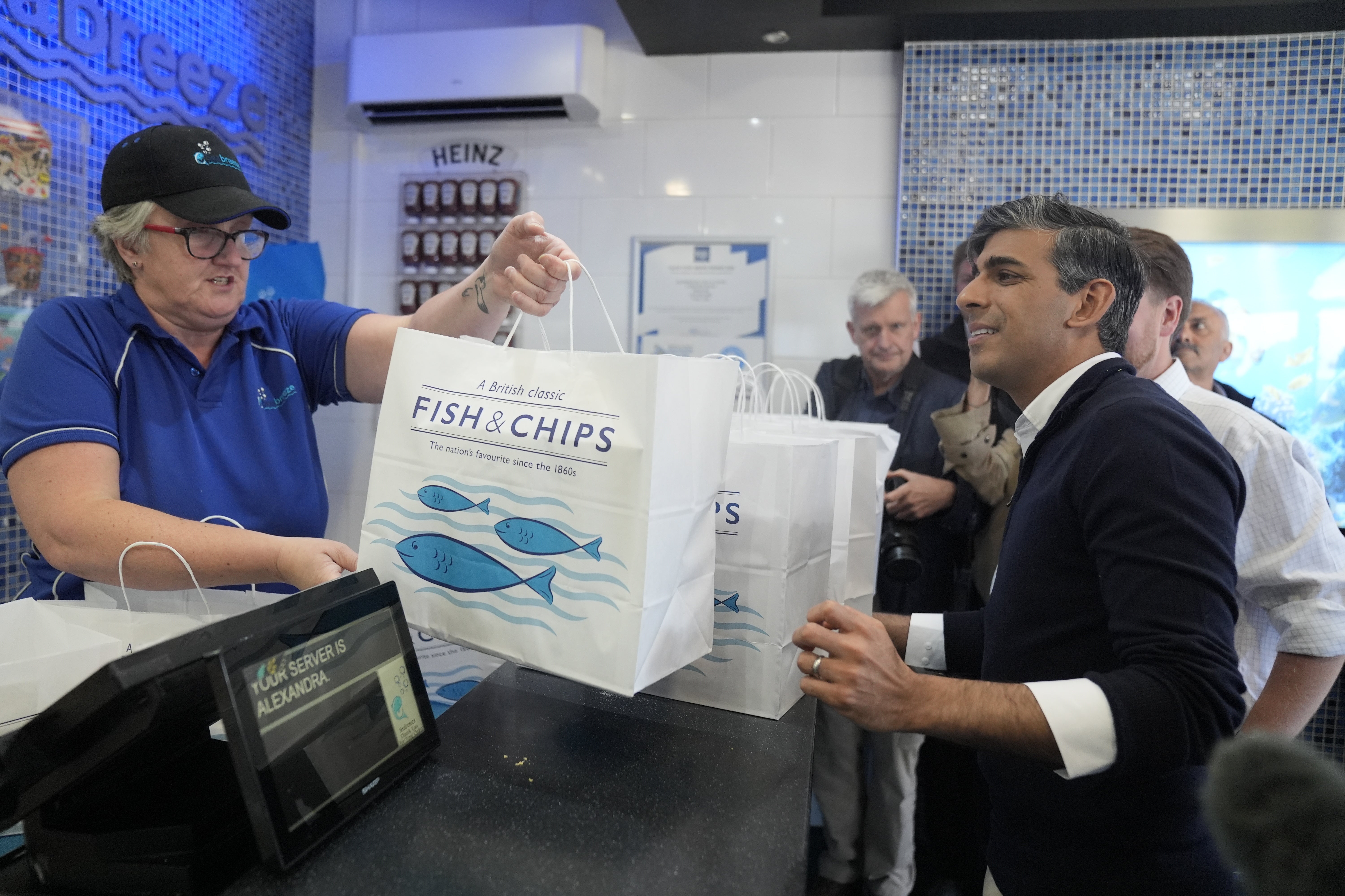 The Prime Minister then treated the media who were following his visit to fish and chips, from Sea Breeze in Redcar (Danny Lawson/PA)