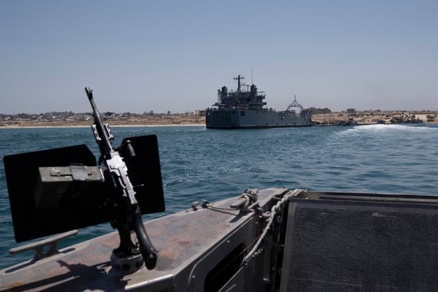 <p>A US Army vessel is seen moored at the U.S.-built floating pier Trident that connects to the beach on the coast of the Gaza Strip</p>