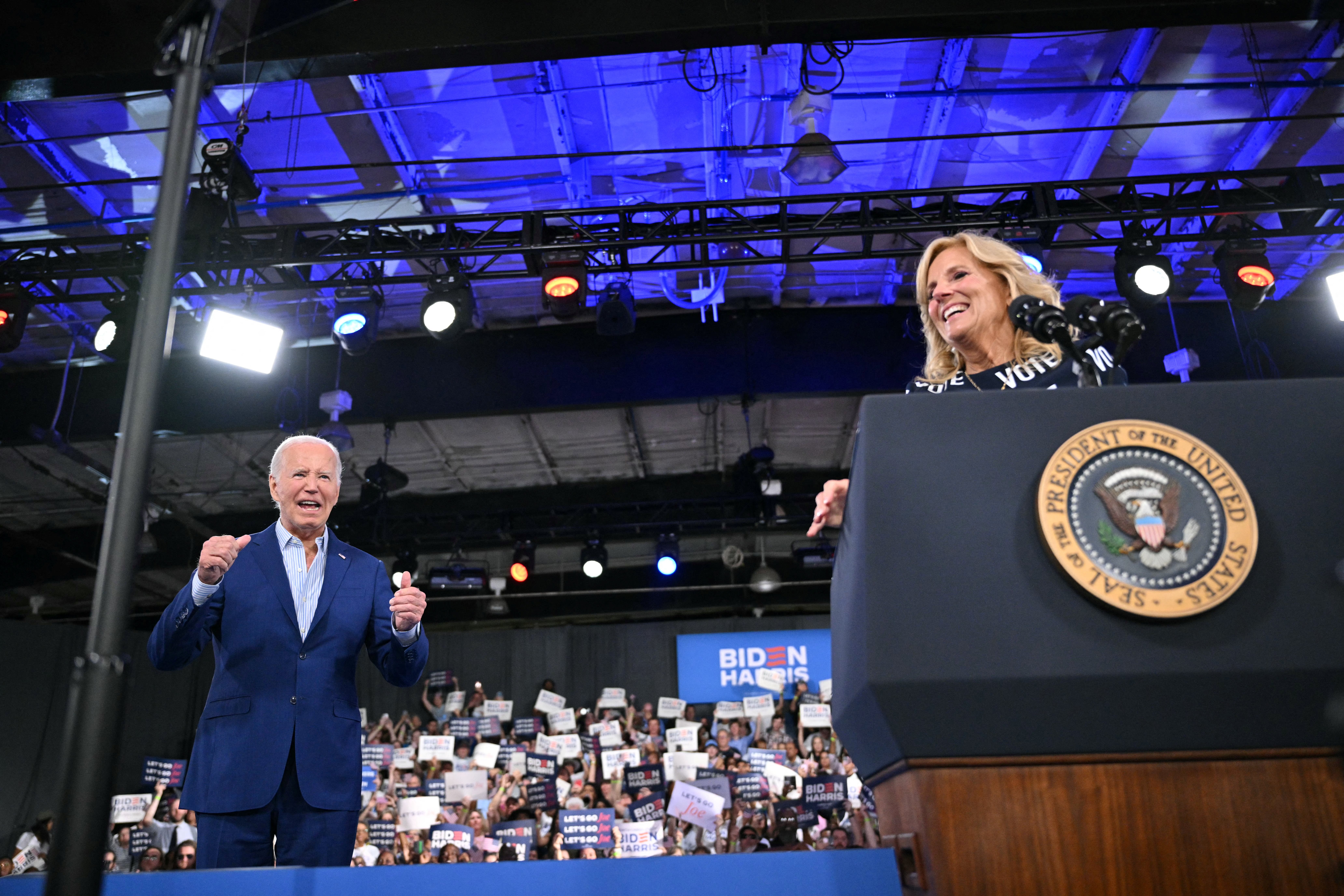 US President Joe Biden responds as First Lady Jill Biden speaks