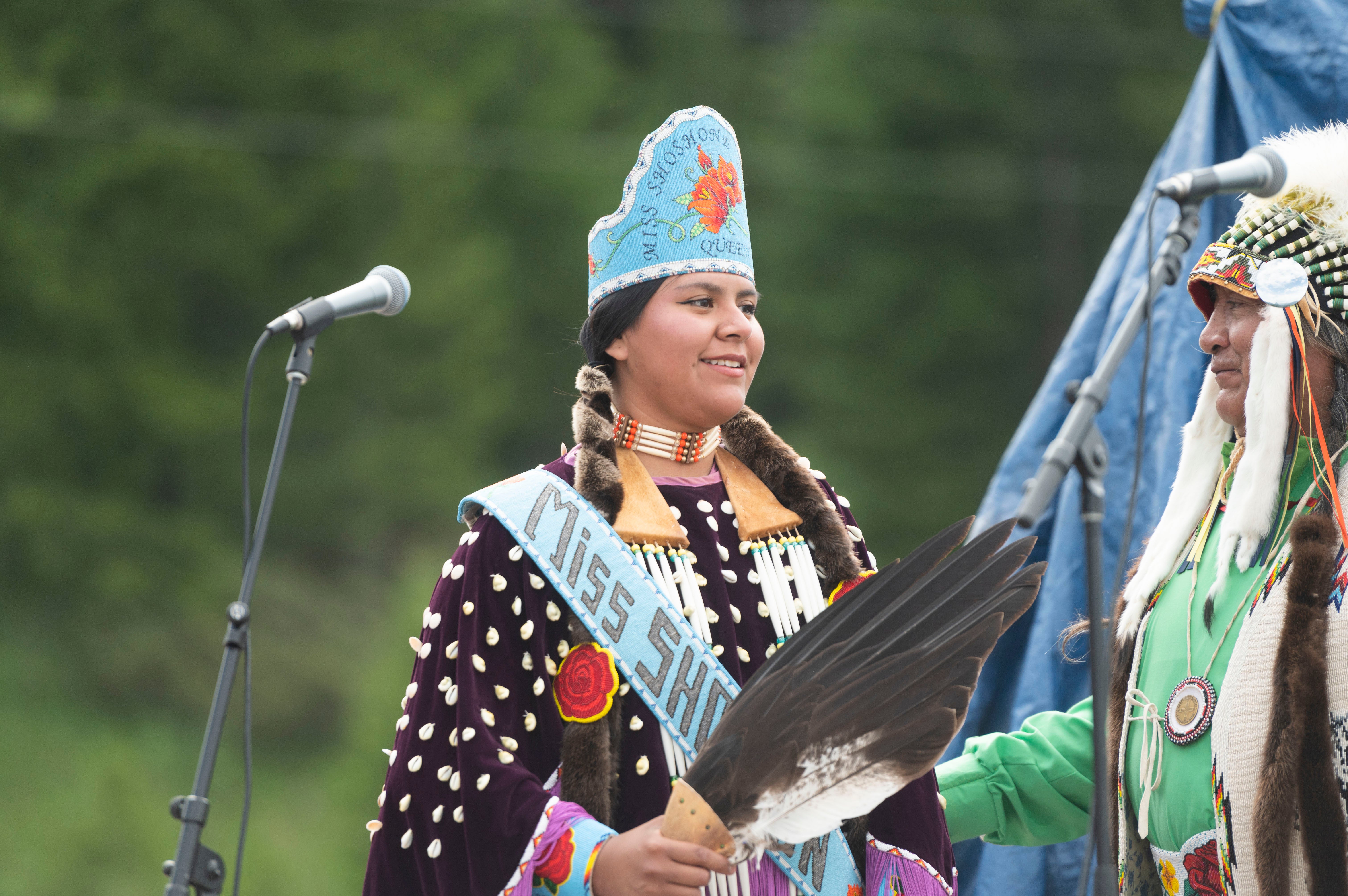 Miss Shoshnone-Bannock Queen Develynn Hall takes the stage during a naming ceremony for a white buffalo calf at the headquarters of the Buffalo Field Campaign. The buffalo has not been seen for weeks after birth.