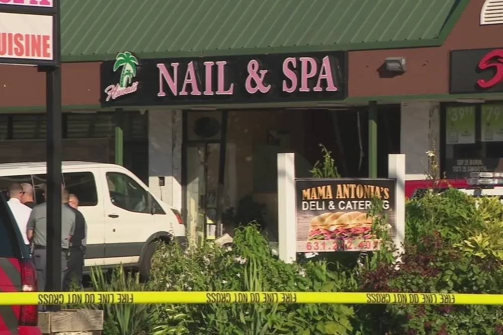 Police and EMS personnel gather outside of a nail salon in Deer Park, New York, on Friday, June 28, 2024, where a minivan crash through a wall and killed four people.