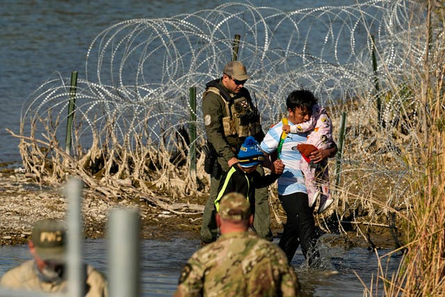 <p>Migrants are taken into custody by officials at the Texas-Mexico border, January 3, 2024, in Eagle Pass, Texas</p>