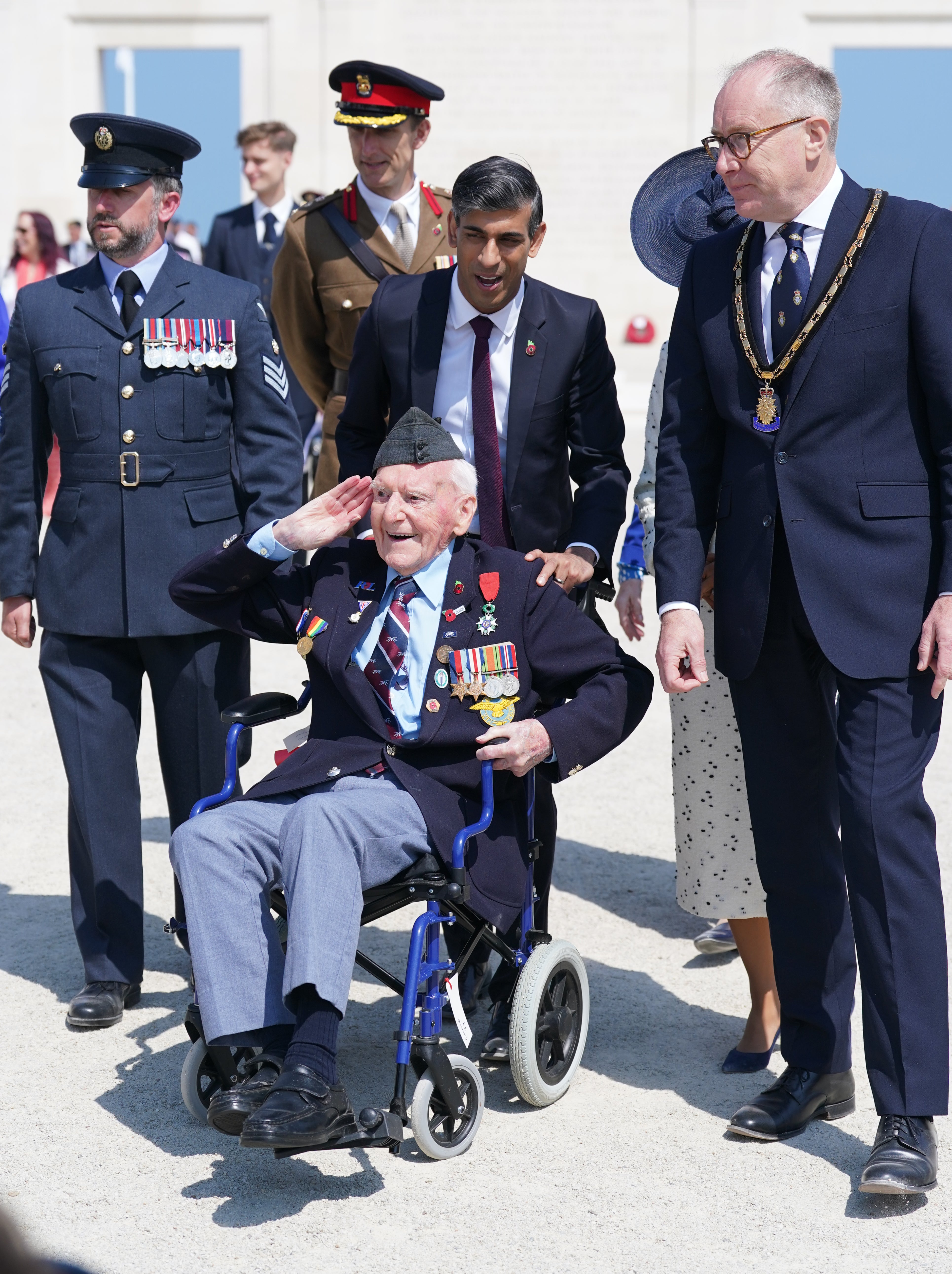 Prime Minister Rishi Sunak wheels D-Day veteran Bernard Morgan, 100, on the 80th anniversary of D-Day (Gareth Fuller/PA)