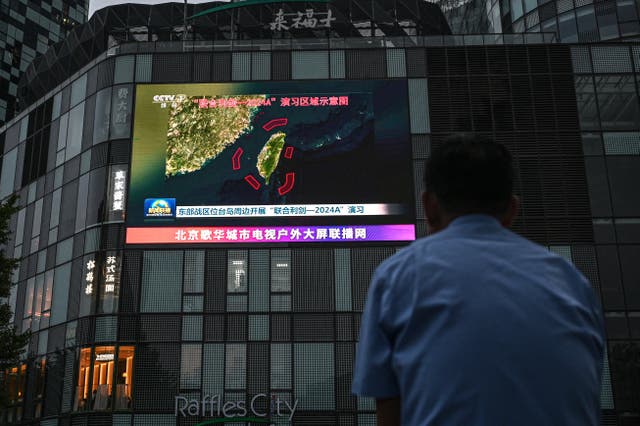 <p>An outdoor screen in Beijing shows news coverage of China’s military drills around Taiwan</p>