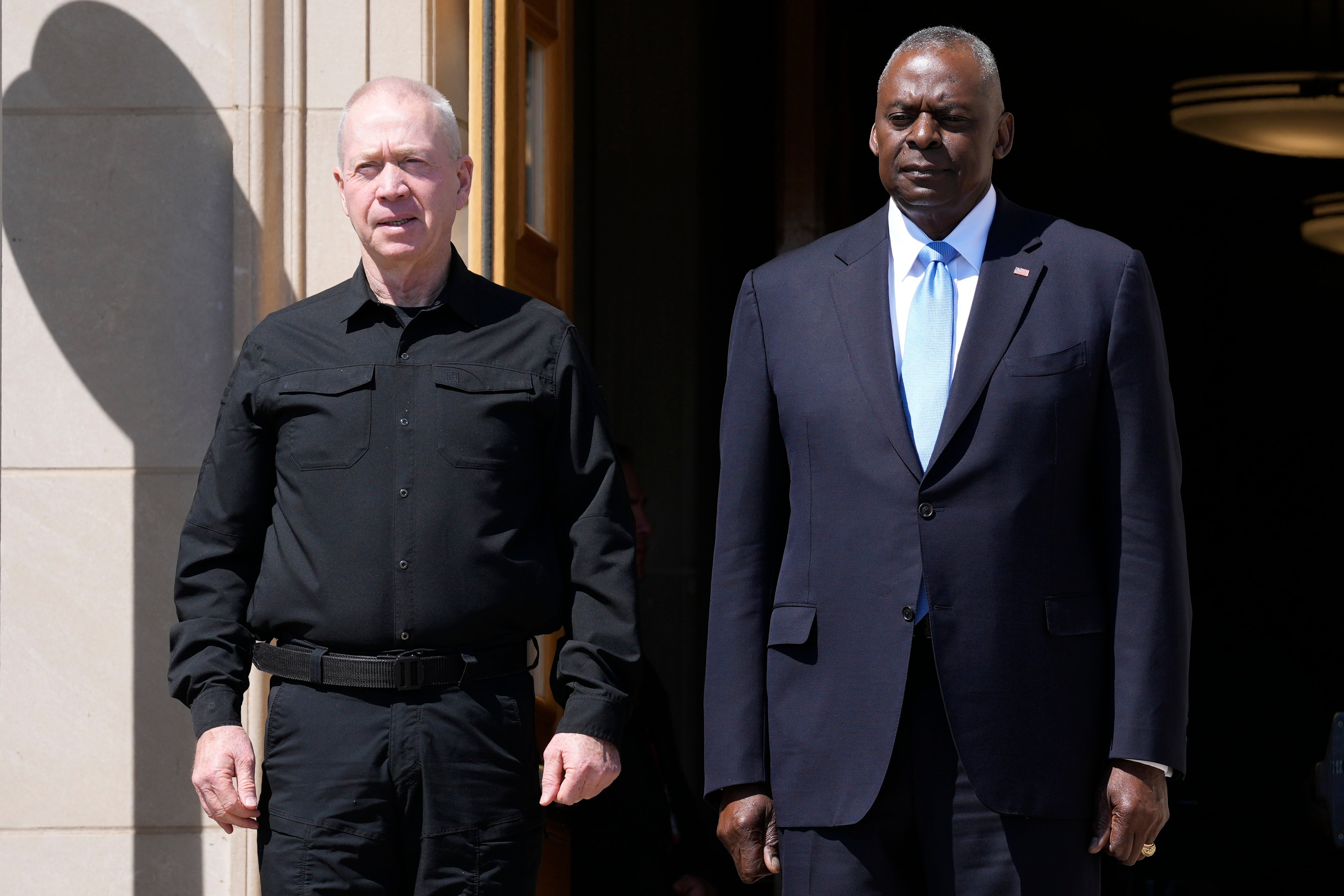 Defense Secretary Lloyd Austin, standing right, and Israeli Defense Minister Yoav Gallant, standing left, listen to the playing of the Israeli National Anthem during an arrival ceremony at the Pentagon in June