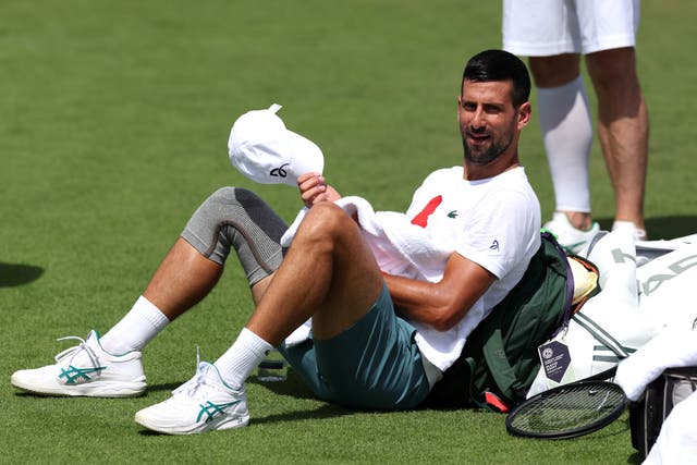 <p>Novak Djokovic takes a break during practice at Wimbledon</p>