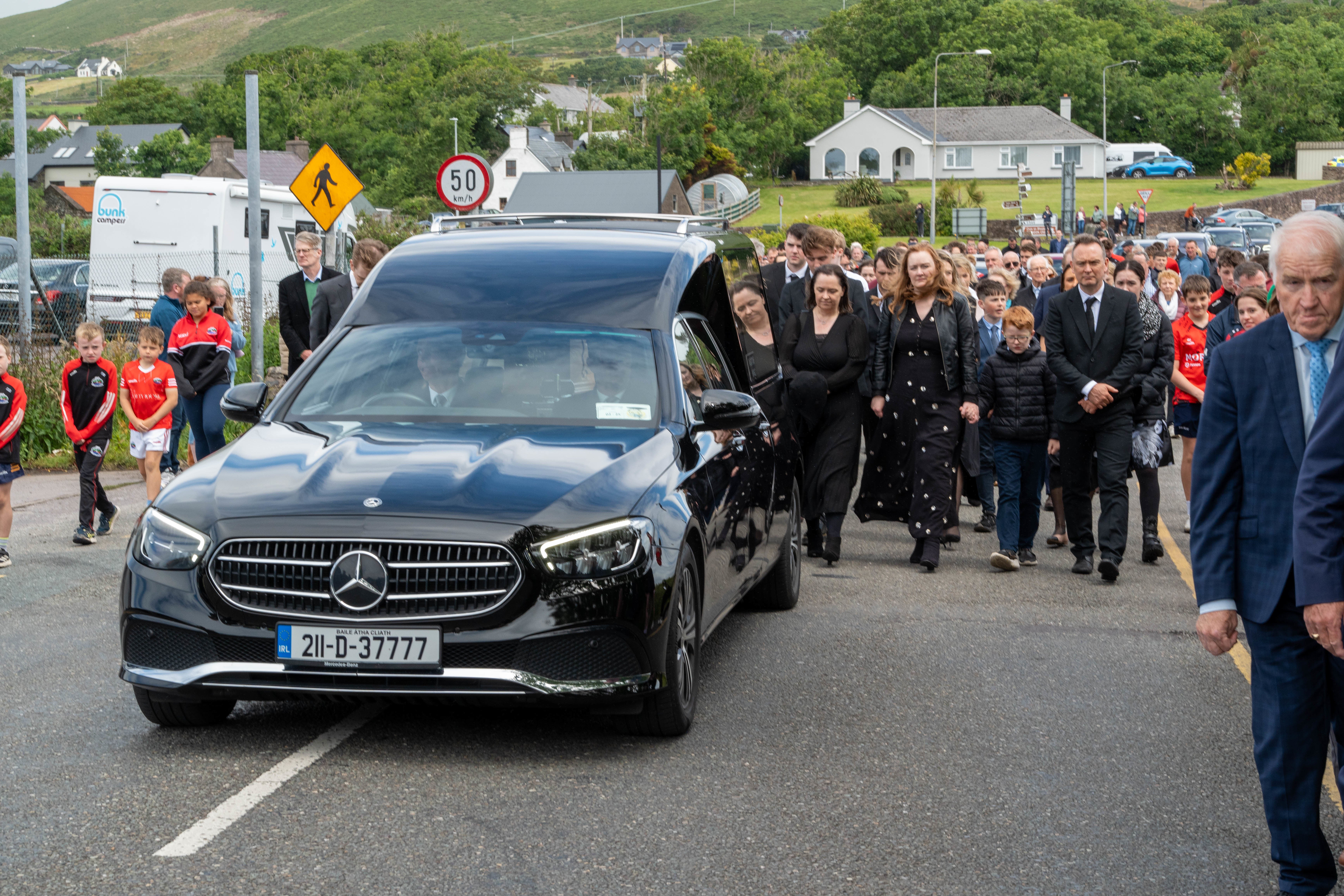 The hearse carrying renowned Gaelic games commentator Micheal O Muircheartaigh following his funeral at St Mary’s Church in Dingle, Co Kerry (Noel Sweeney/PA)