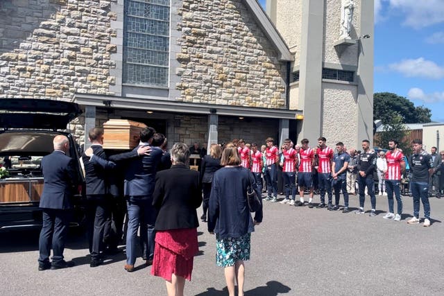 Sligo Rovers players line up as the coffin of veteran RTE journalist Tommie Gorman is carried into in Our Lady Star of the Sea Church in Ransboro, Co Sligo for his funeral (PA)