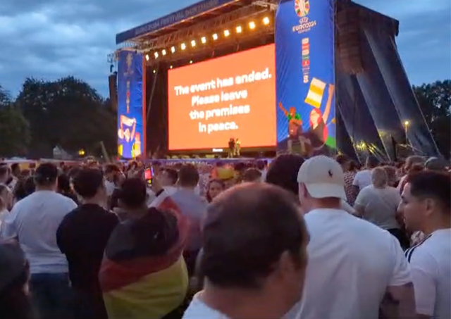 <p>Fans react as the Westfalenpark fan park is closed during the match</p>