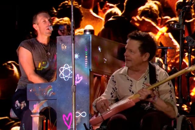 Chris Martin performs with Michael J Fox on the Pyramid Stage at Glastonbury