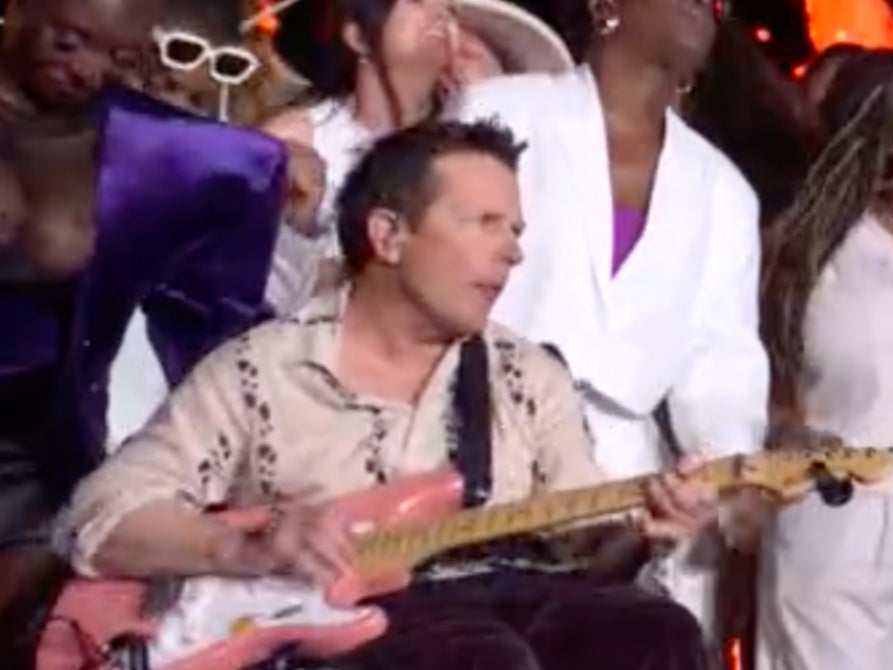 Michael J Fox plays guitar during Coldplay’s Glastonbury headline set