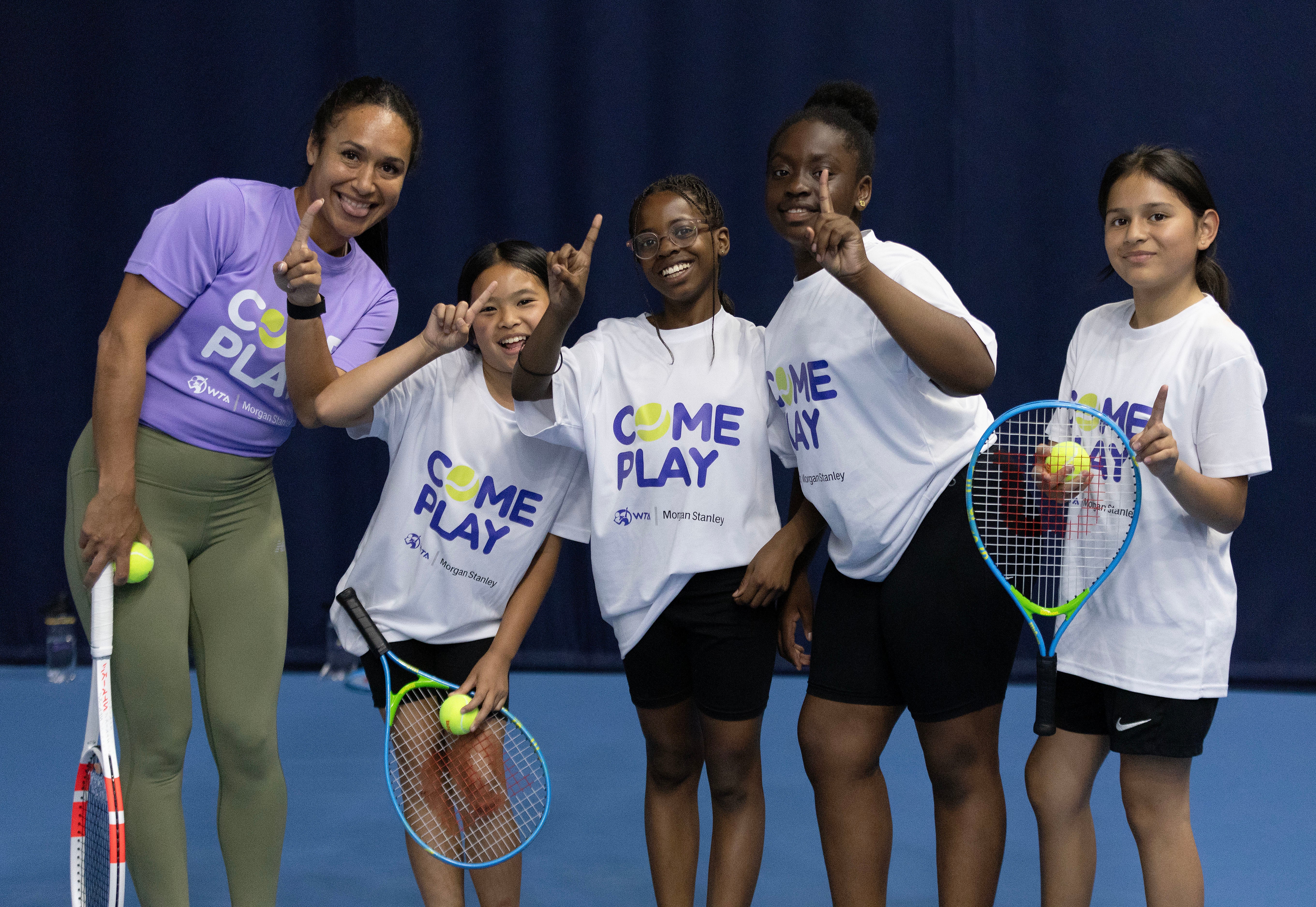 Heather Watson, left, poses with children from Elena Baltacha’s Foundation during a Come Play presented by Morgan Stanley day in London (WTA)