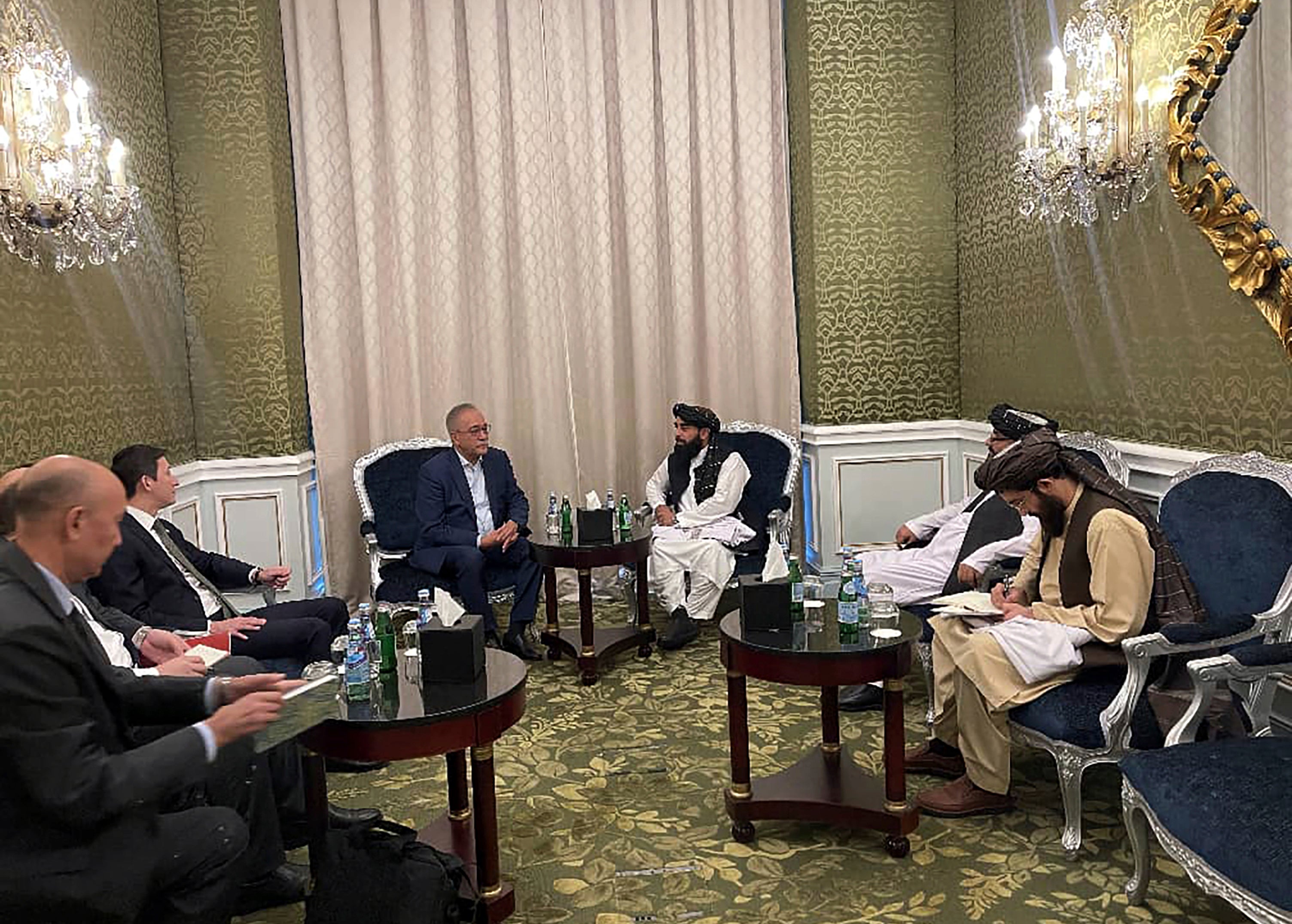 Zabihullah Mujahid, the chief spokesman for the Taliban government speaks with Uzbekistan Presidential Envoy to Afghanistan Ismatullah Irgashev in Doha, Qatar
