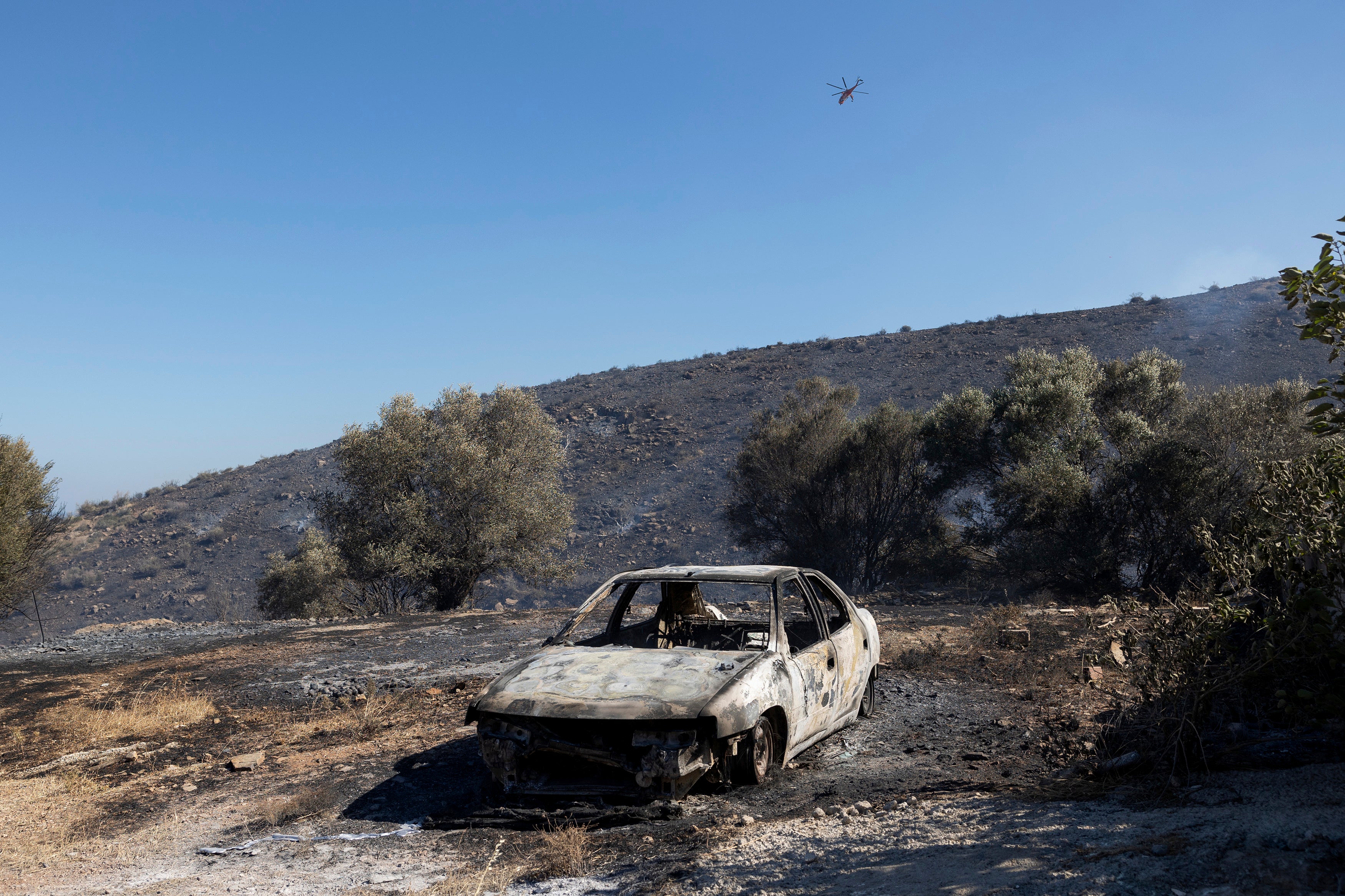 A burnt car after a wildfire