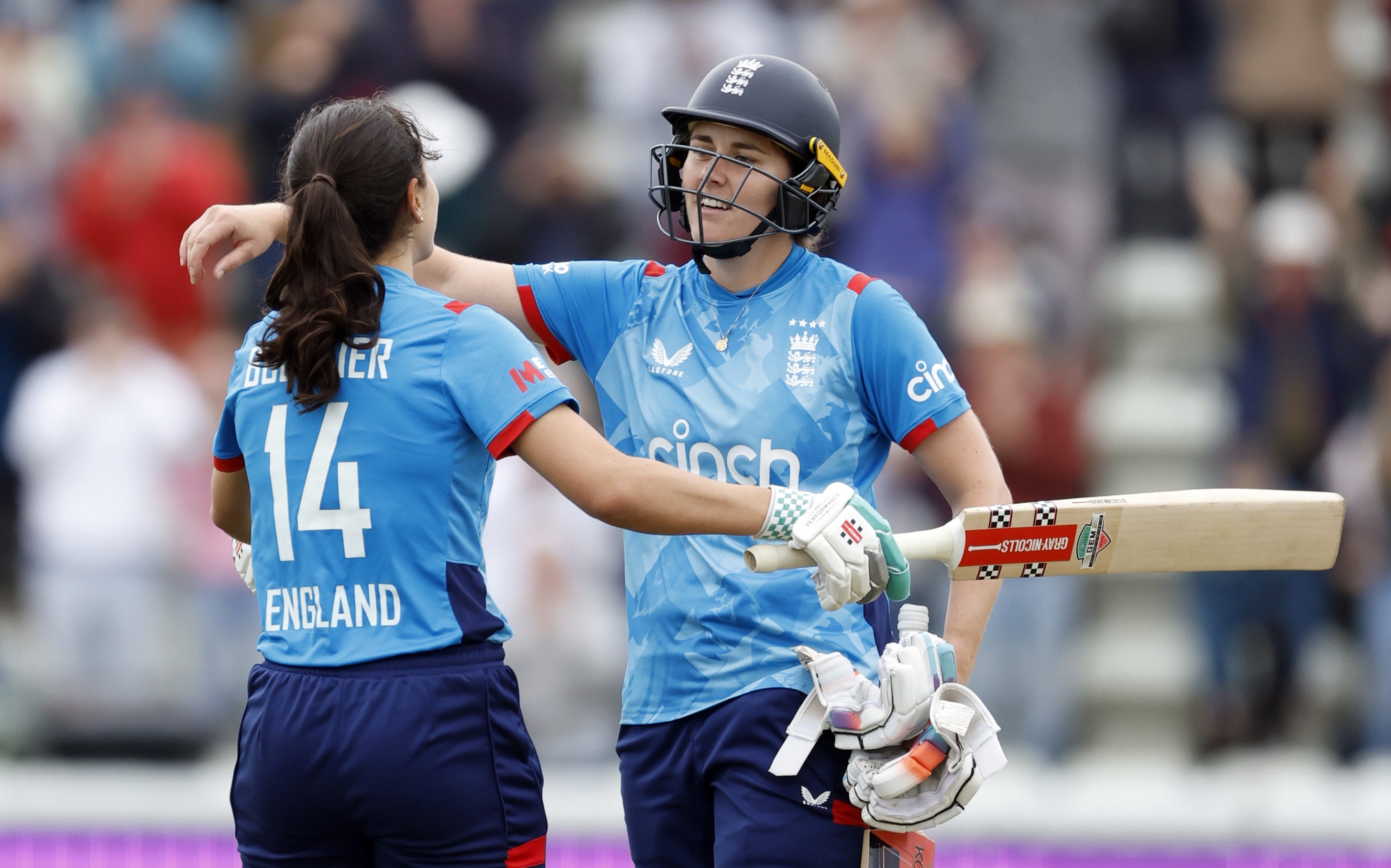 Maia Bouchier celebrates after reaching her century with Natalie Sciver-Brunt, who played a key role in the landmark hundred (Nigel French/PA)
