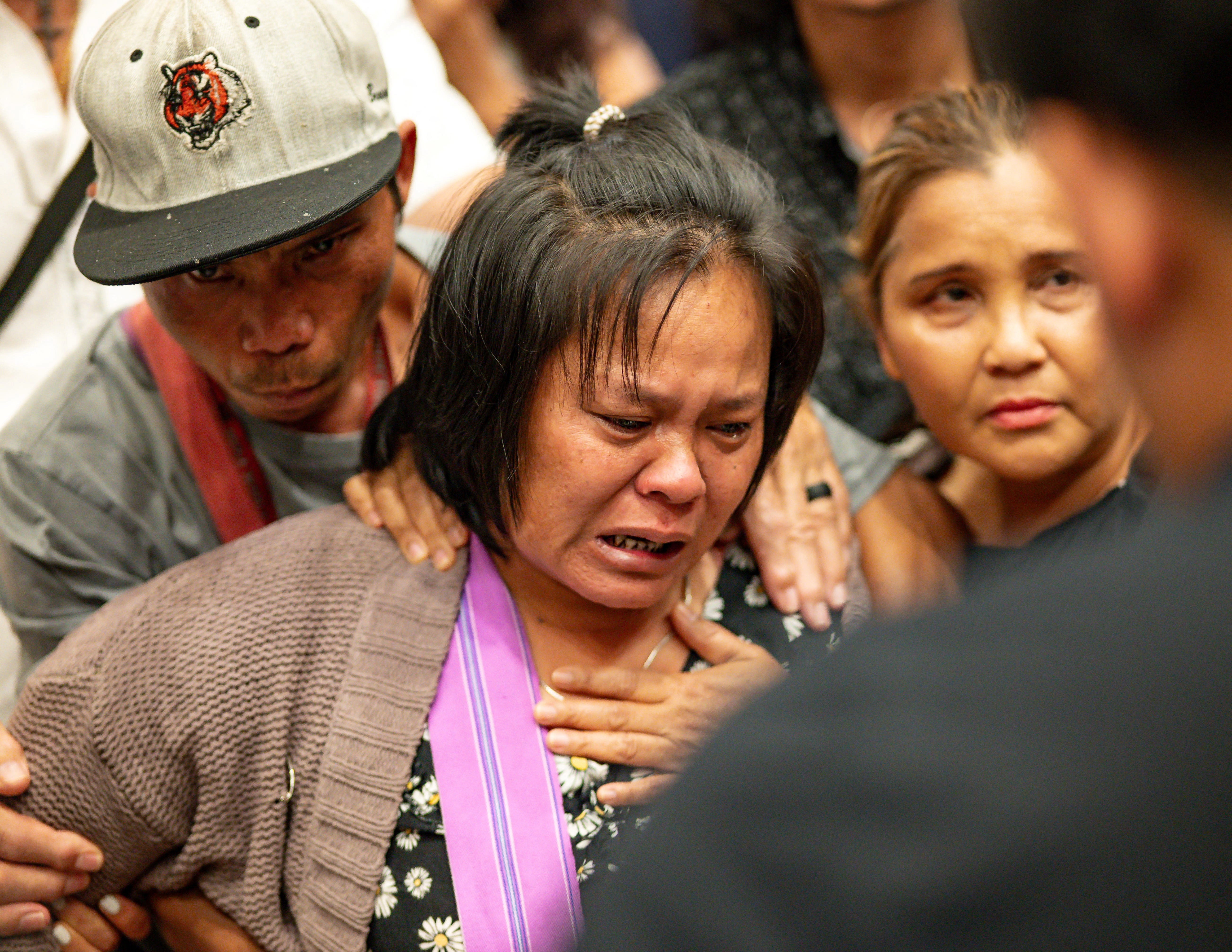 The mother of the 13 year old boy who was shot and killed by Utica Police cries after listening to a translator inside City Hall in Utica, New York on June 29, 2024