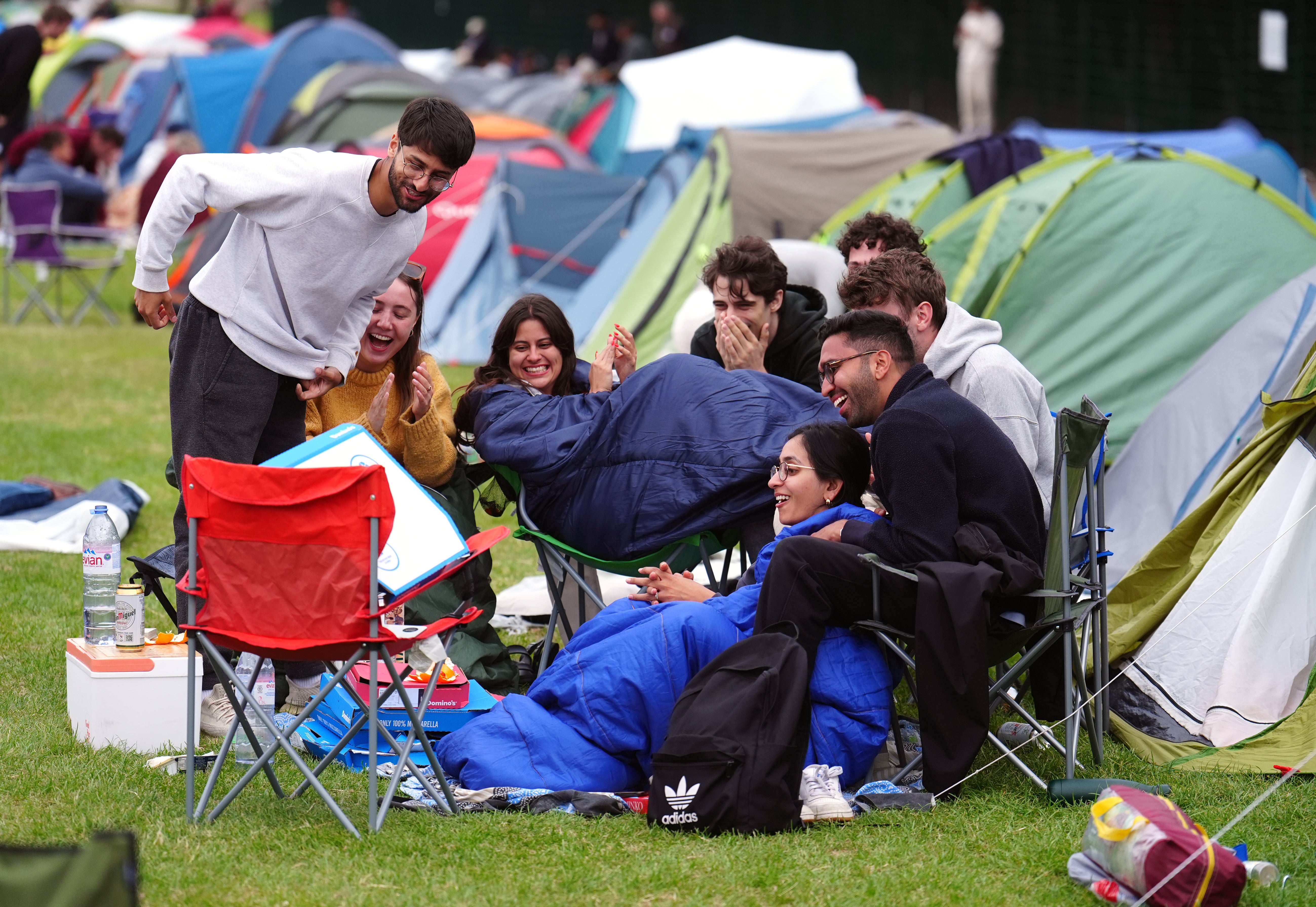 People in the overnight queue for the the Wimbledon championships watching the England v Slovakia match (Mike Egerton/PA)