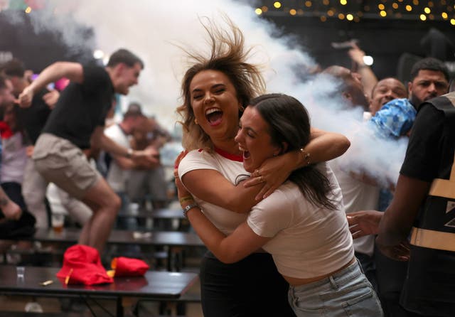 <p>England fans at BOXPARK Wembley celebrate Bellingham’s equaliser (Steven Paston/PA)</p>