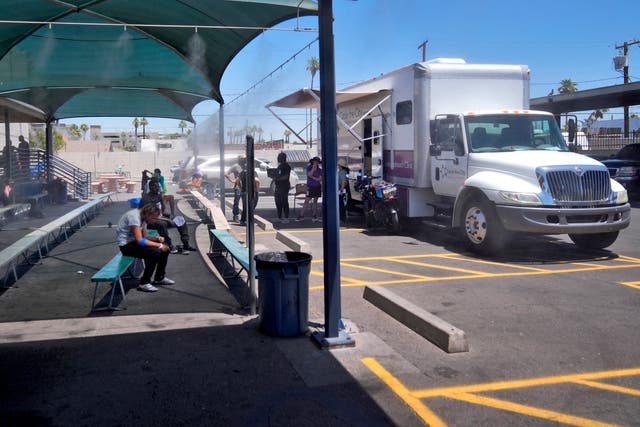 <p>Patients gather outside one of the five Circle The City mobile clinics stationed outside a soup kitchen for homeless people, May 30, 2024 in Phoenix</p>