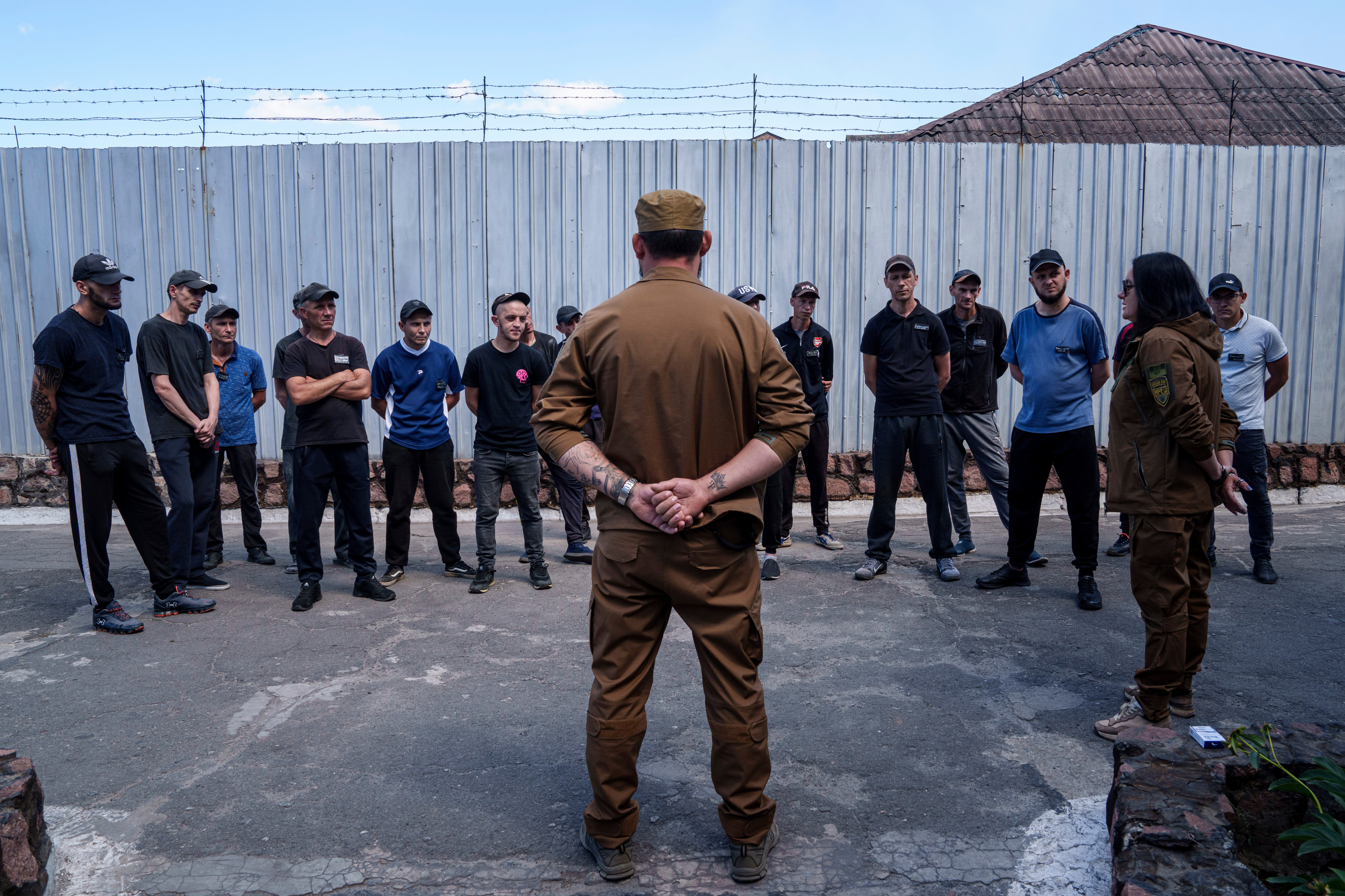 Prisoners listen to a Ukrainian sergeant of the Battalion Arey during an interview in a prison, in the Dnipropetrovsk region