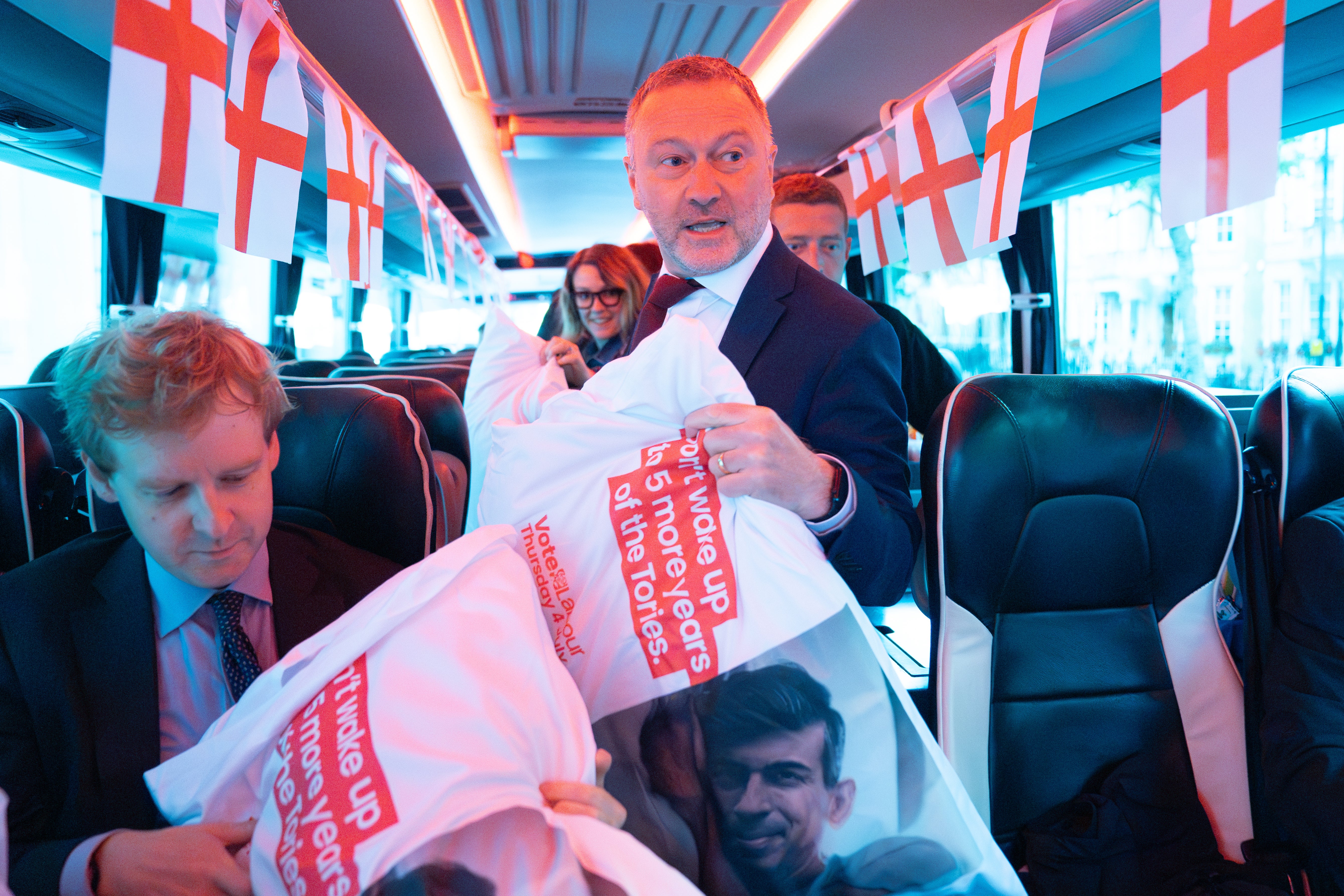 Shadow environment secretary Steve Reed hands out pillows to journalists, printed with a mocked-up photo of Rishi Sunak in bed and the words "Don't wake up to five more years of the Tories”