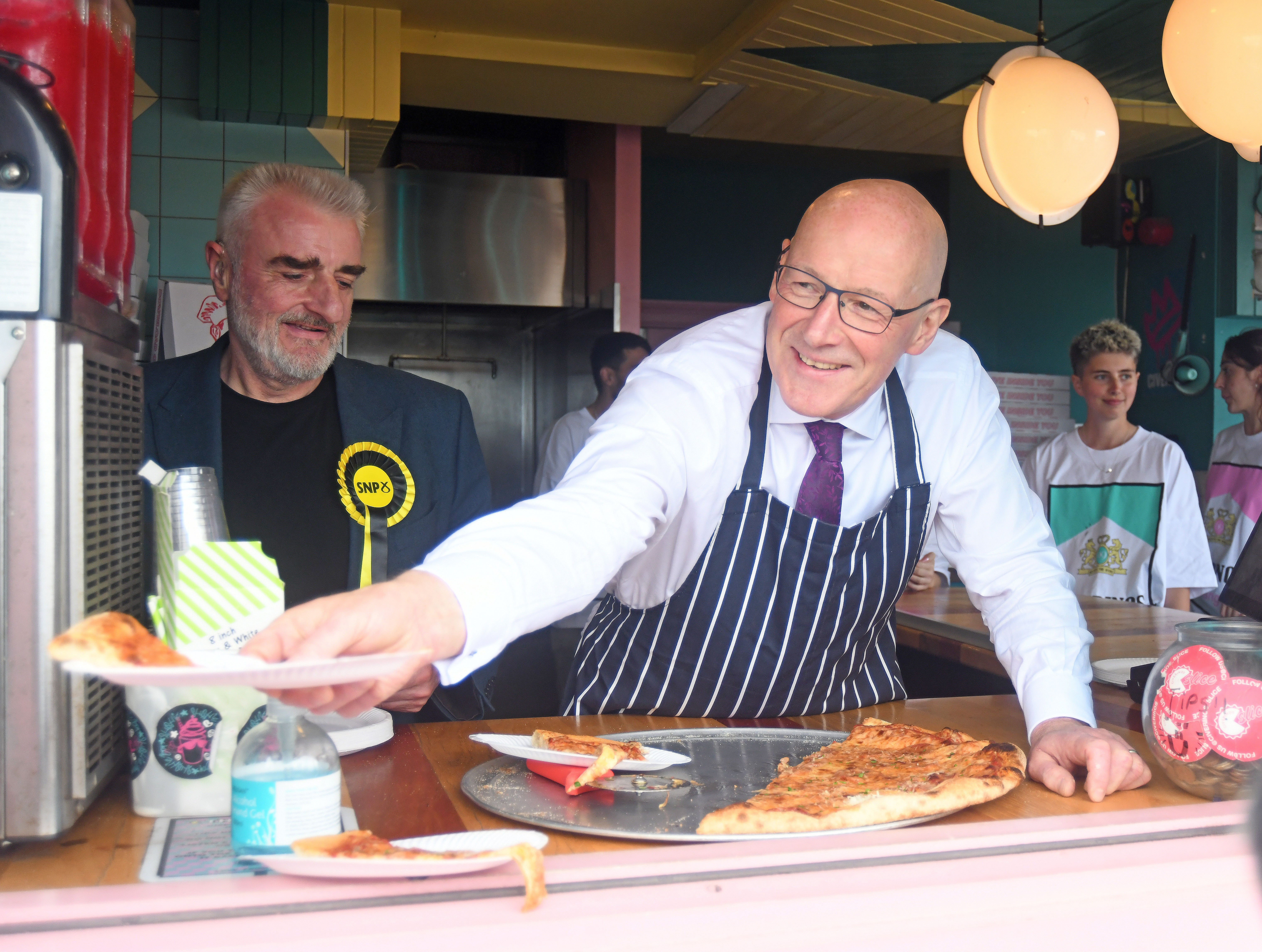 SNP Leader John Swinney (right) joins the SNP candidate for Edinburgh East and Musselburgh, Tommy Sheppard, serving pizza at Portobello Beach and Promenade,