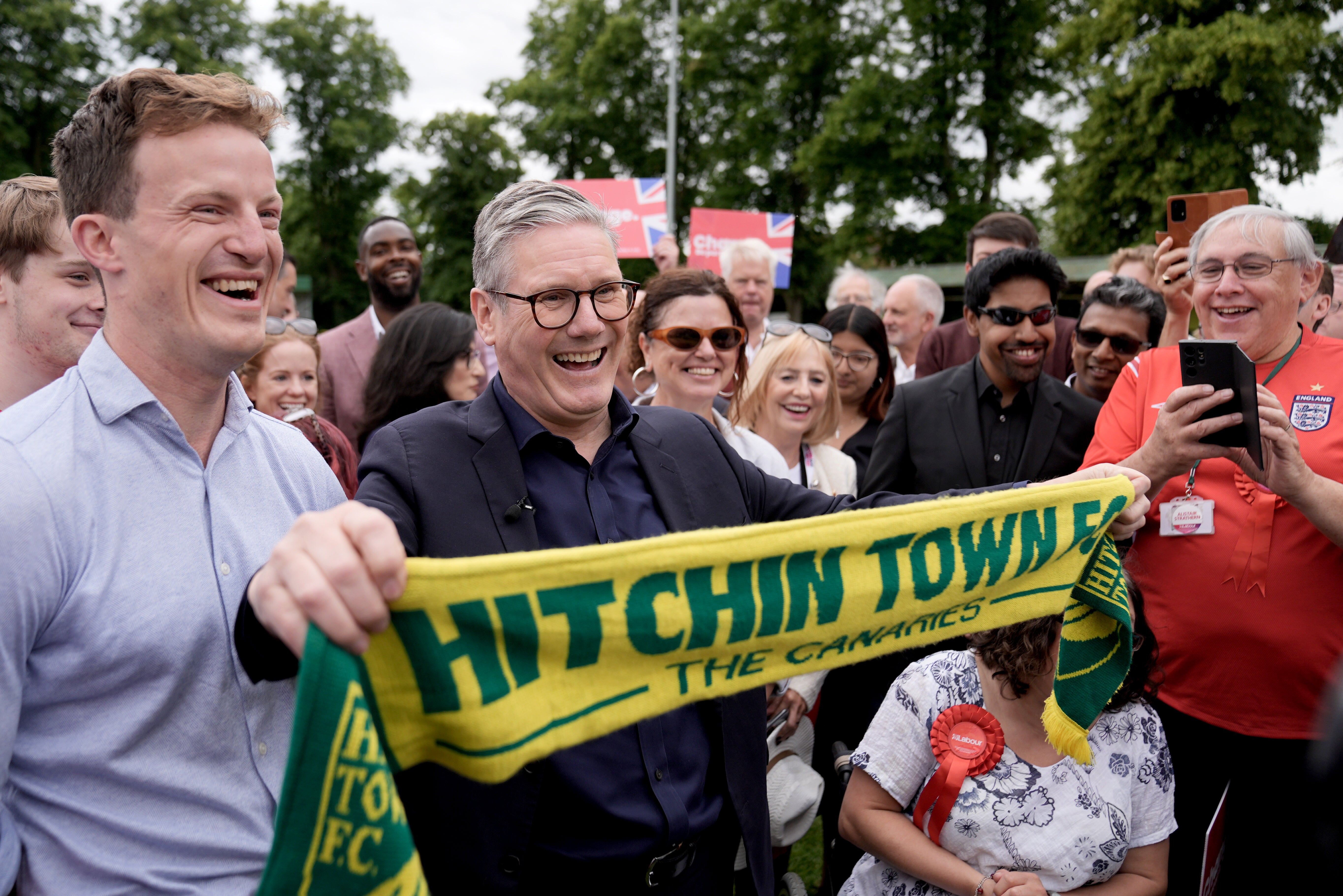Labour leader Sir Keir Starmer holds up a Hitchin Town FC scarf during a visit to Hitchin, Hertfordshire, while on the General Election campaign trail. Picture date: Monday July 1, 2024.