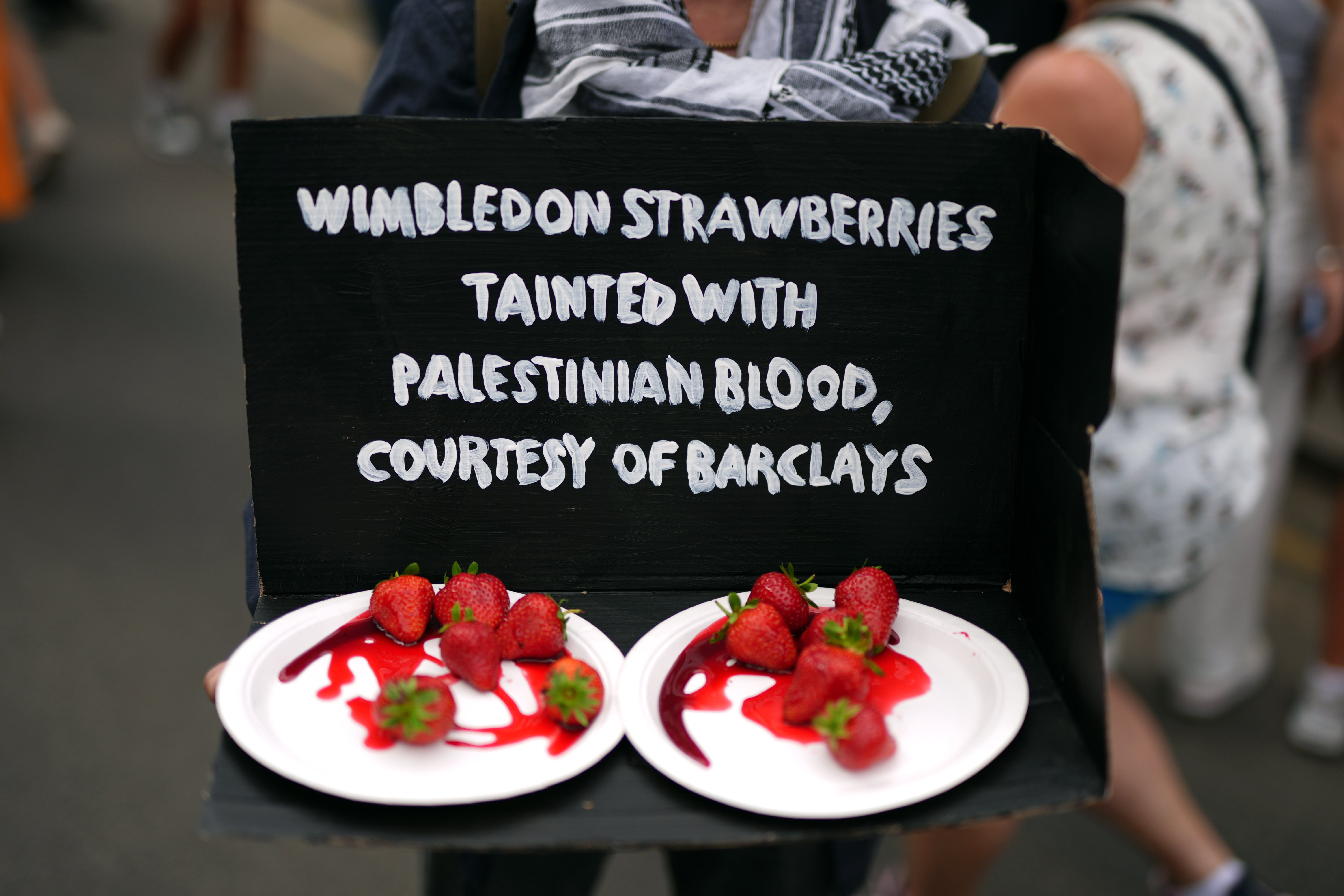 Protesters used Wimbledon’s iconic strawberries in their demonstration (Jordan Pettitt/PA)