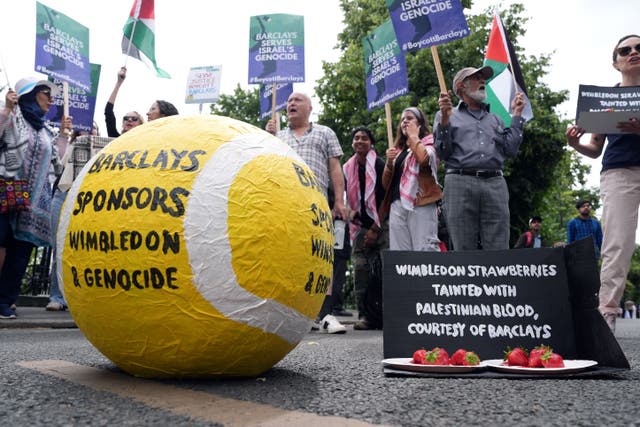 People protesting against Barclays sponsorship of the Wimbledon Championships (Jordan Pettitt/PA)