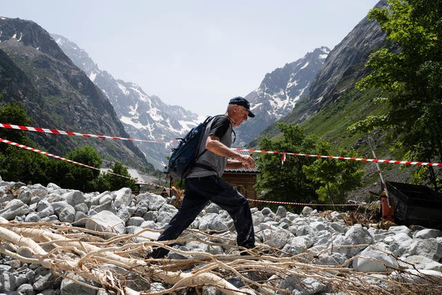 <p>A local resident walks amid debris to collect belongings from his destroyed home following a devastating flood of the river Veneon last week</p>