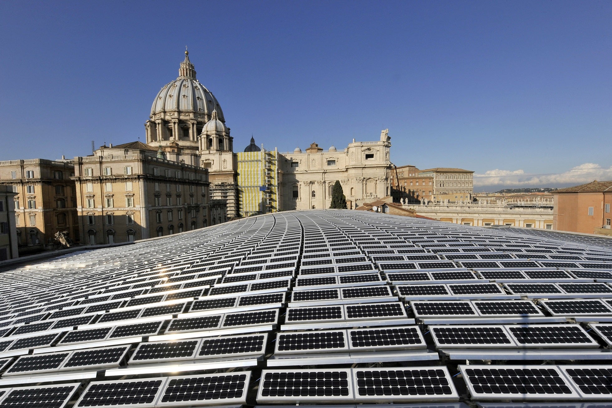 Solar panels covering the roof of the Paul VI audience hall at the Vatican with the Basilica of Saint Peter in the background on 26 November, 2008