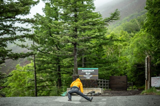 <p>A staffer works out in front the newly installed trail gate at Fuji Subaru Line 5th station, which leads to the Yoshida trail to climb Mount Fuji</p>