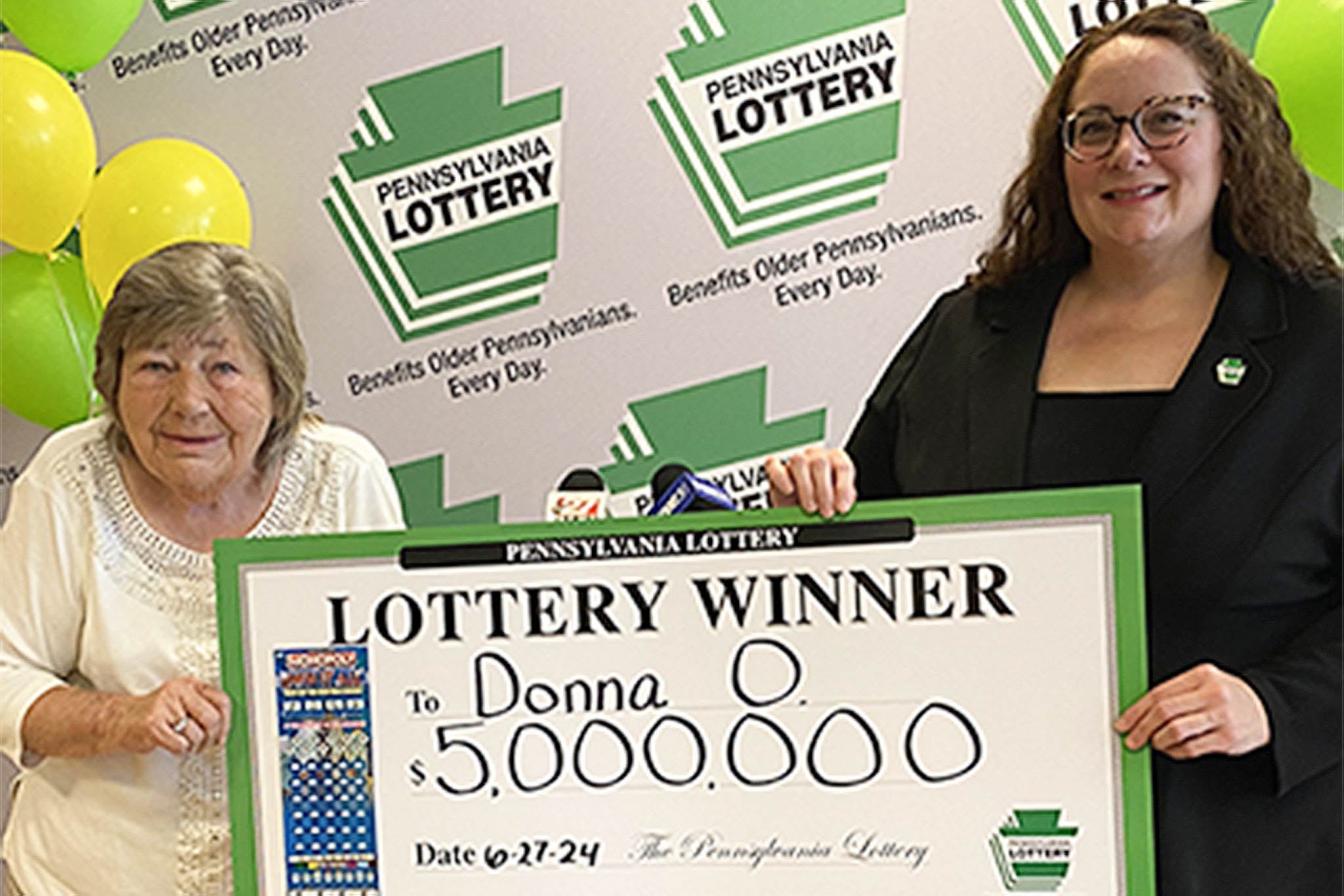 Donna Osborne (left), aged 75, holding her commemorative check for $5m after winning a Lottery scratch-off