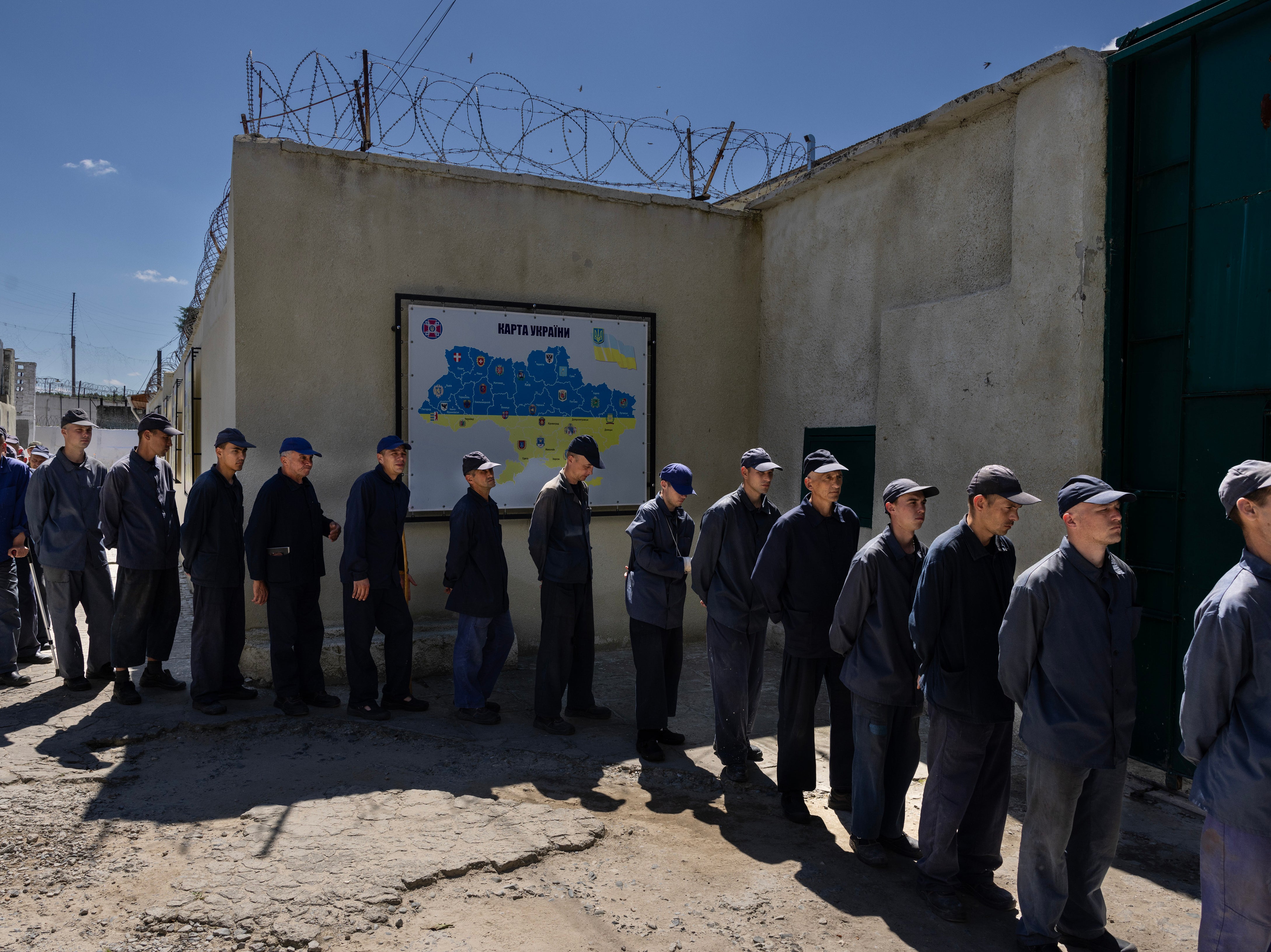 Russian prisoners of war line up at a camp in Lyiv, Ukraine