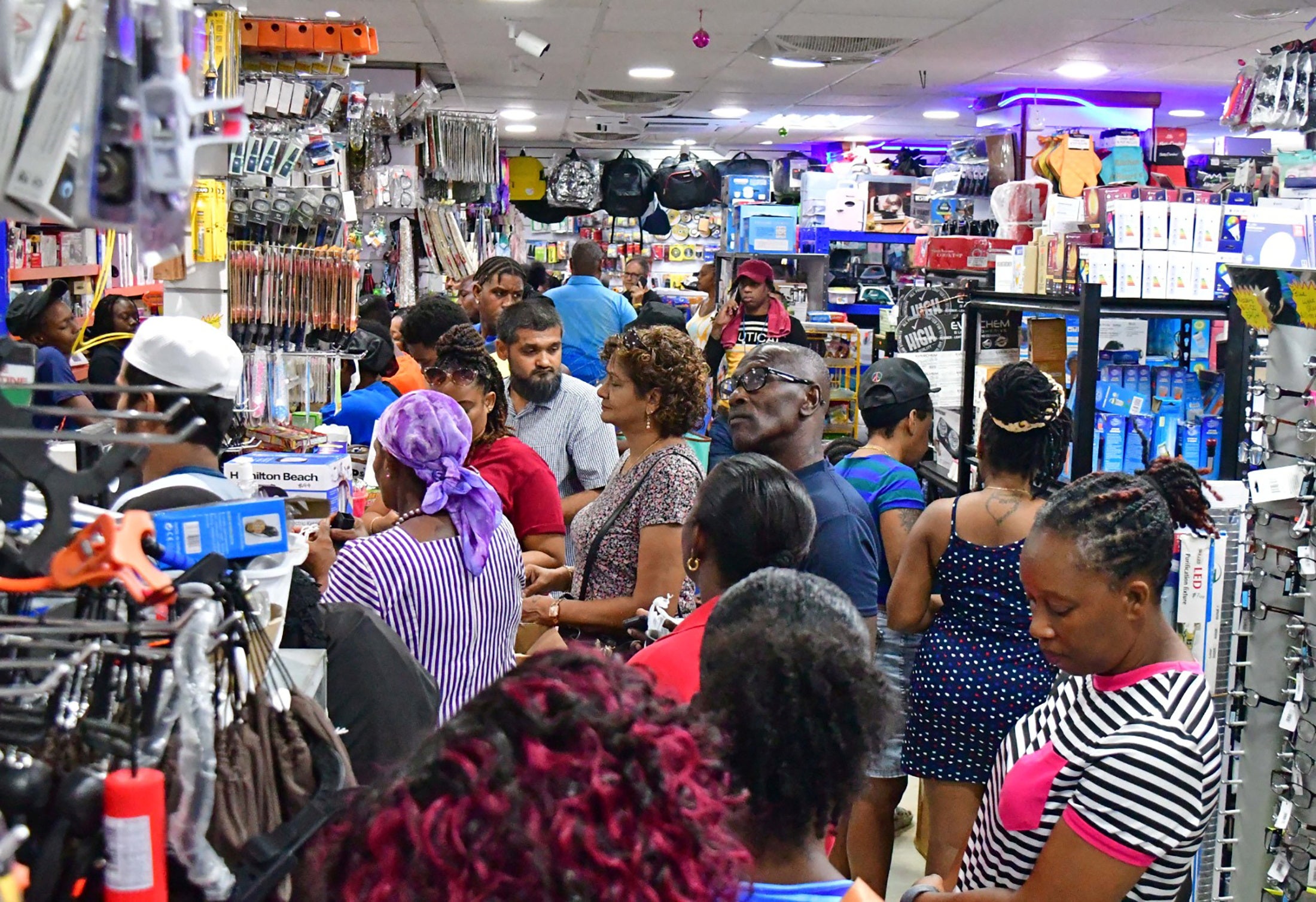 People shop for supplies in Bridgetown, Barbados on Sunday as Hurricane Beryl races towards the eastern Caribbean