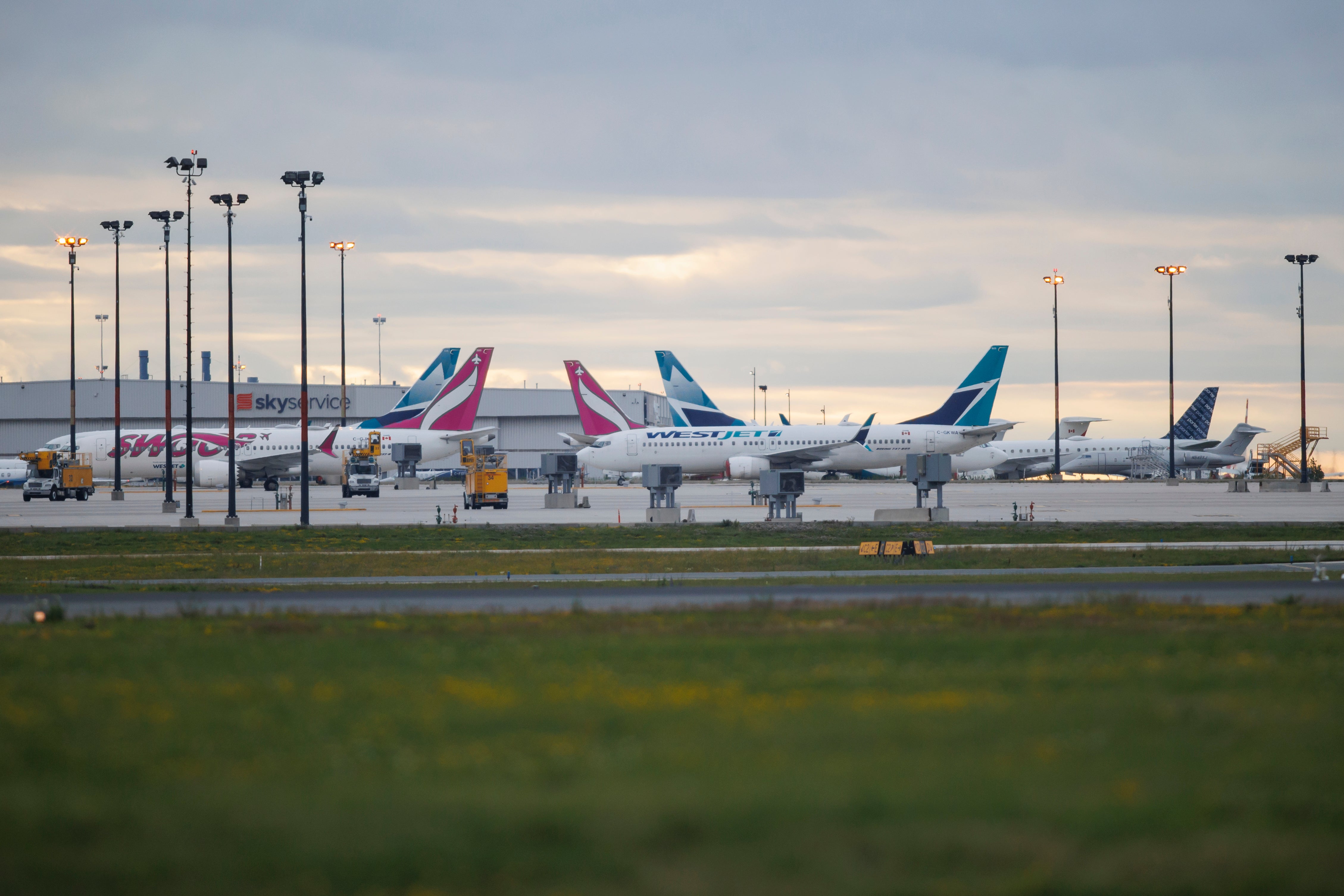 Westjet planes are seen parked at a Westjet hangar at Toronto Pearson International airport on Sunday. WestJet canceled 832 flights between last Thursday and Tuesday, over the country’s Canada Day holiday weekend.
