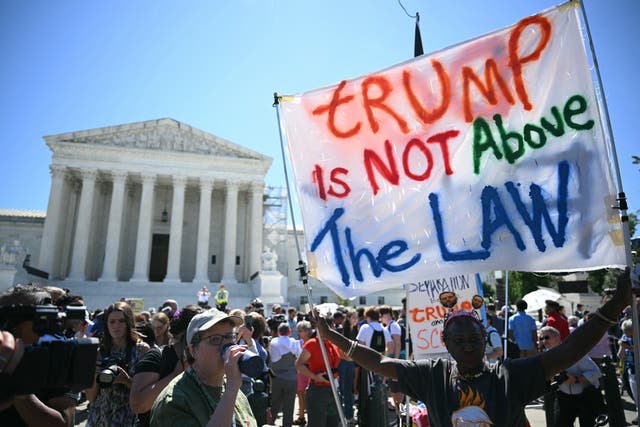 <p>Protesters gather outside the Supreme Court on July 1, 2024 as justices grant Donald Trump partial immunity from prosecution in his election interference case</p>