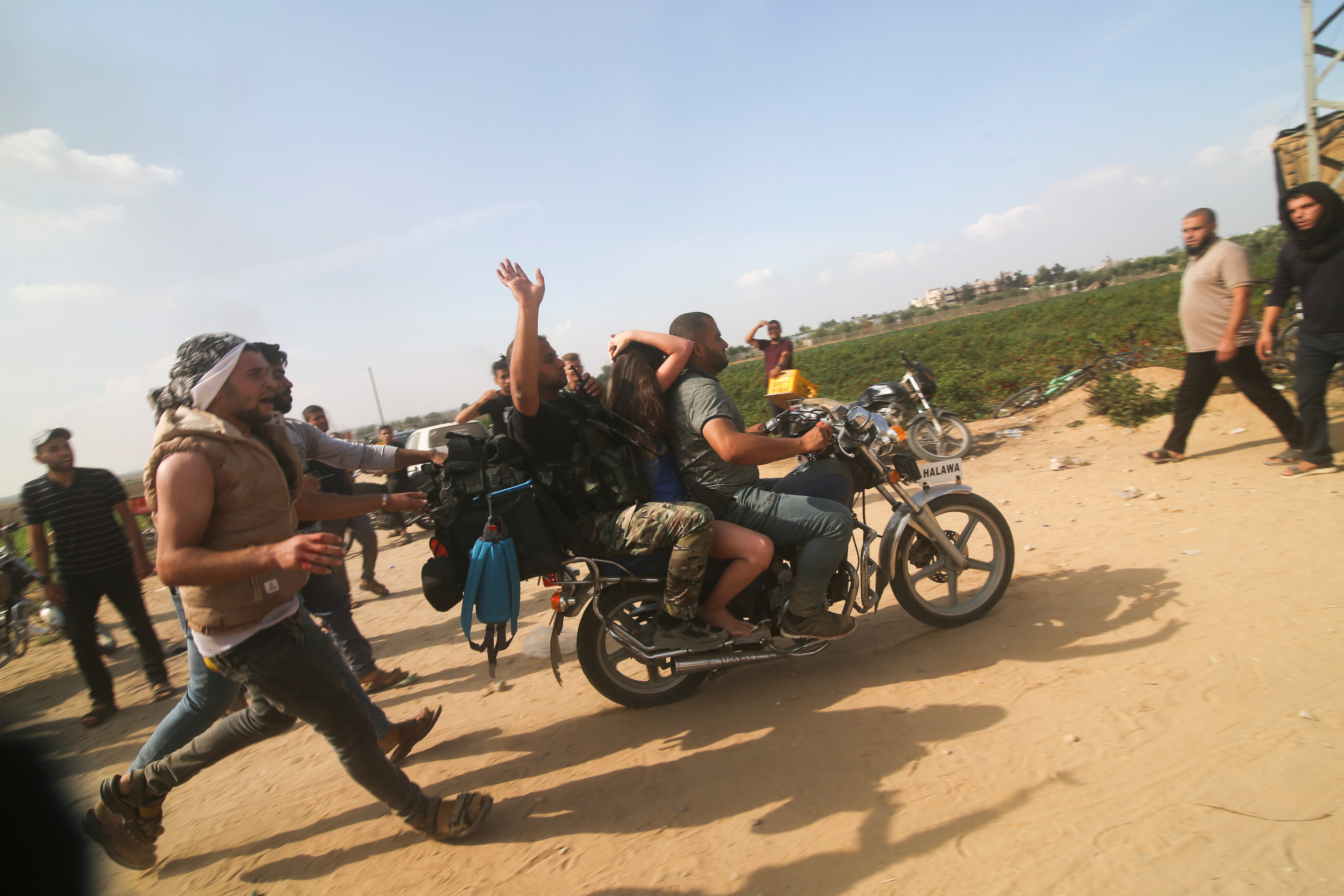 Palestinians transport a captured Israeli civilian, Noa Argamani, on a motorcycle from southern Israel, in the Gaza Strip on Oct. 7, 2023