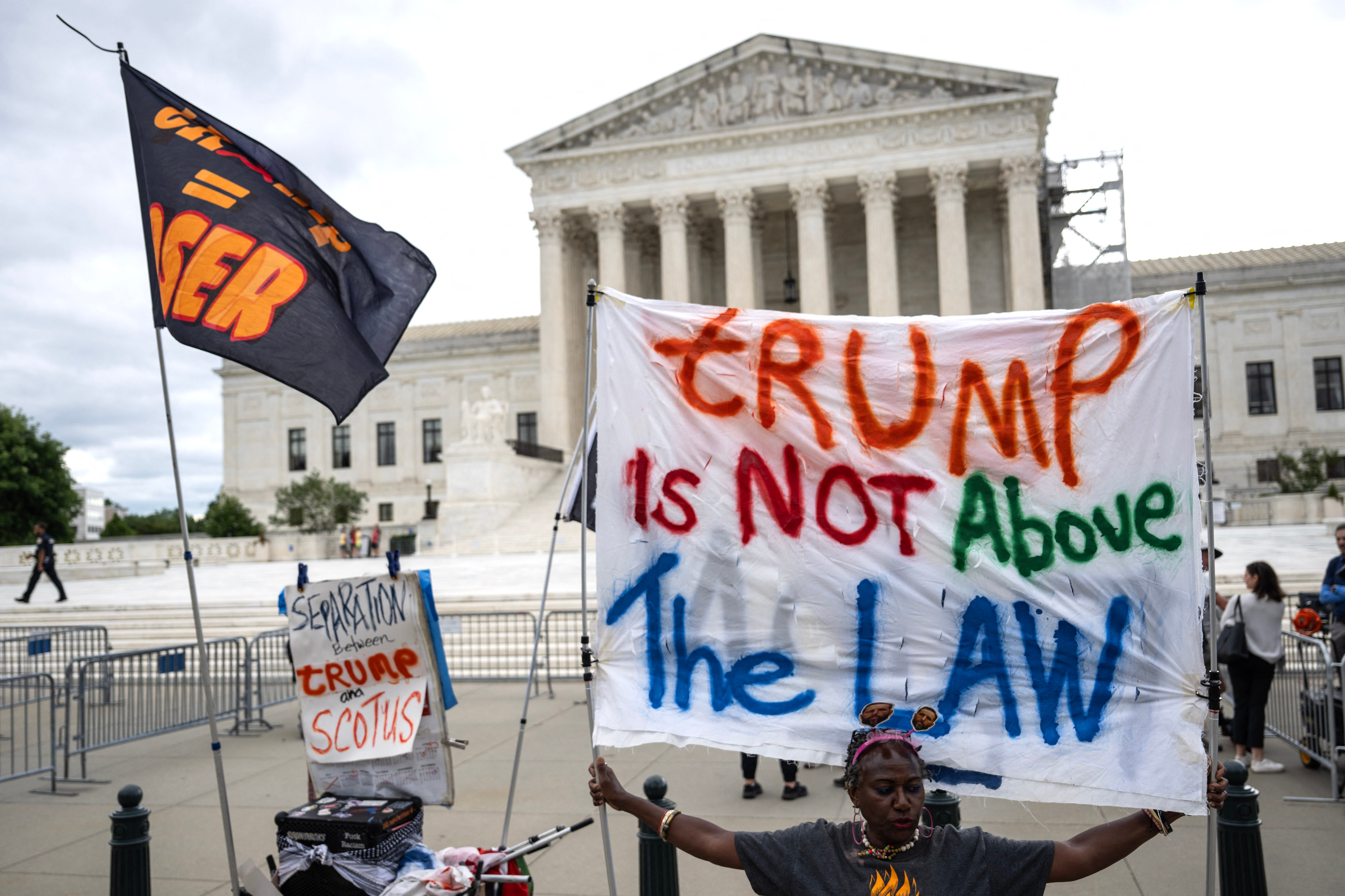 Anti-Trump protesters outside the US Supreme Court after Monday’s ruling