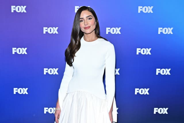 <p>Olivia Culpo walked down the aisle in a modest white gown with long sleeves and a full-coverage crew neckline </p>