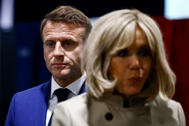 <p>French President Emmanuel Macron and his wife Brigitte Macron stand in the voting station before voting in Le Touquet-Paris-Plage, northern France</p>