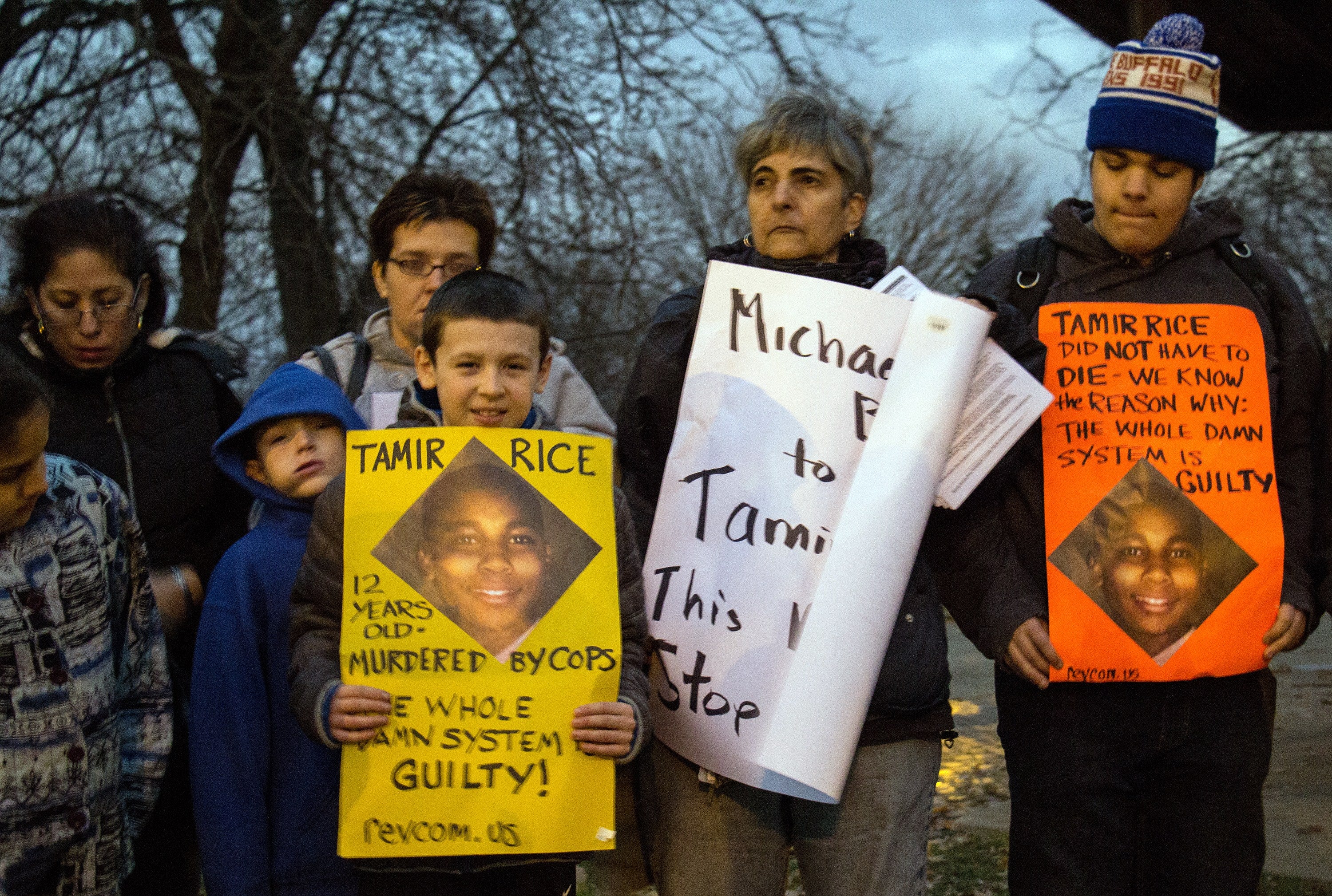 People display sigs at Cudell Commons Park in Cleveland, Ohio, November 24, 2014 during a rally for Tamir Rice, a 12-year-old boy shot by police on November 23