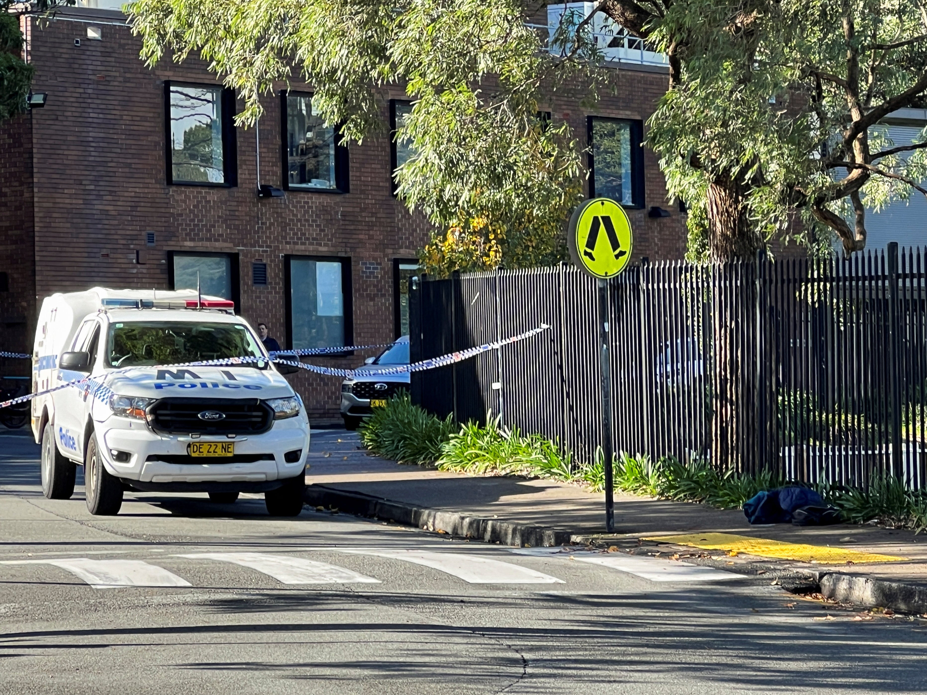 A police vehicle is seen at the scene after a 14-year-old boy was arrested and a 22-year-old man was taken to hospital following a stabbing incident at the University of Sydney in Camperdown, Australia, 2 July 2024