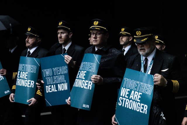 Aer Lingus pilots march around Dublin Airport as they begin their eight-hour strike on Saturday in a bitter dispute with the airline over pay (Evan Treacy/PA)