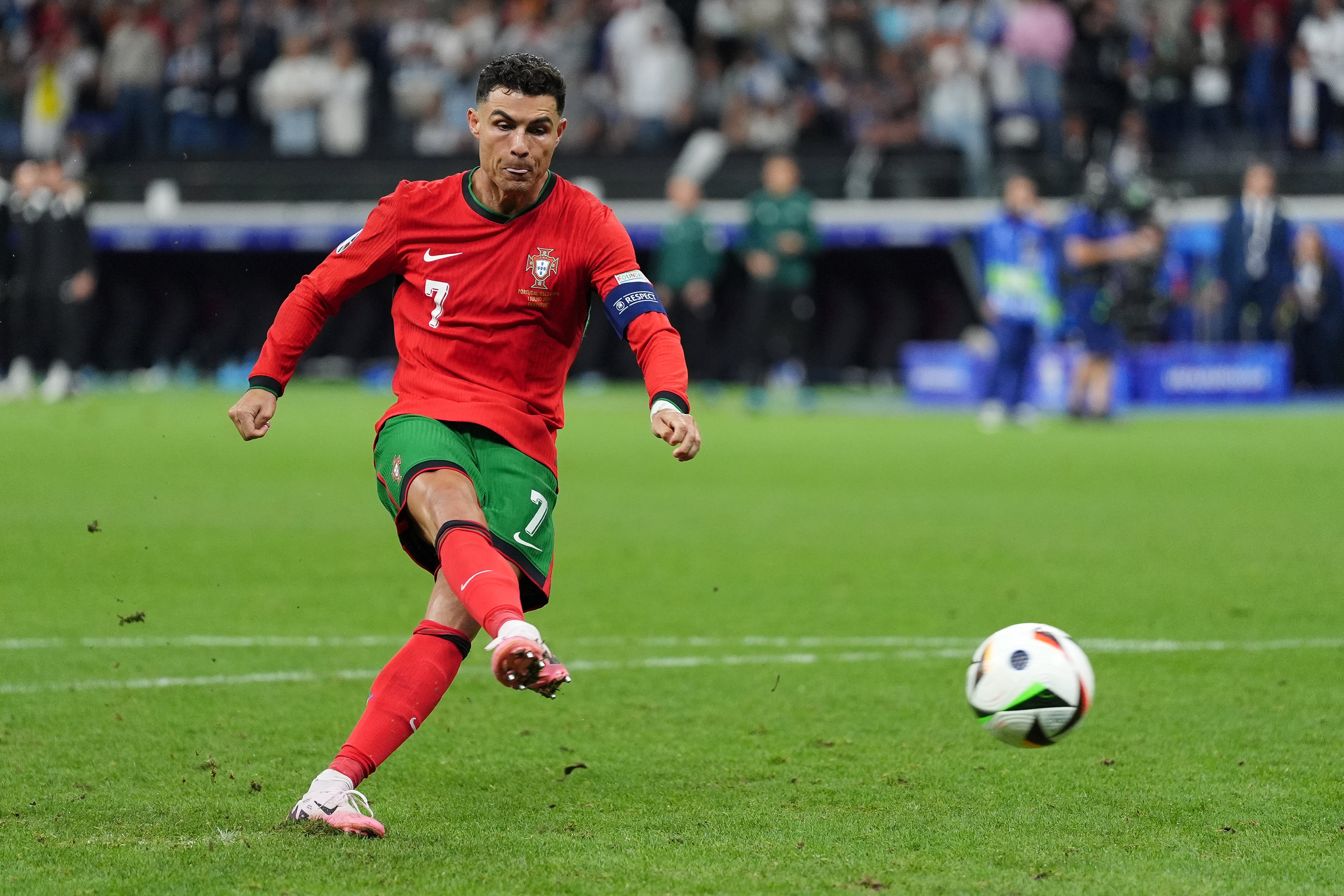 Cristiano Ronaldo scores in the penalty shoot-out against Slovenia (Bradley Collyer/PA)