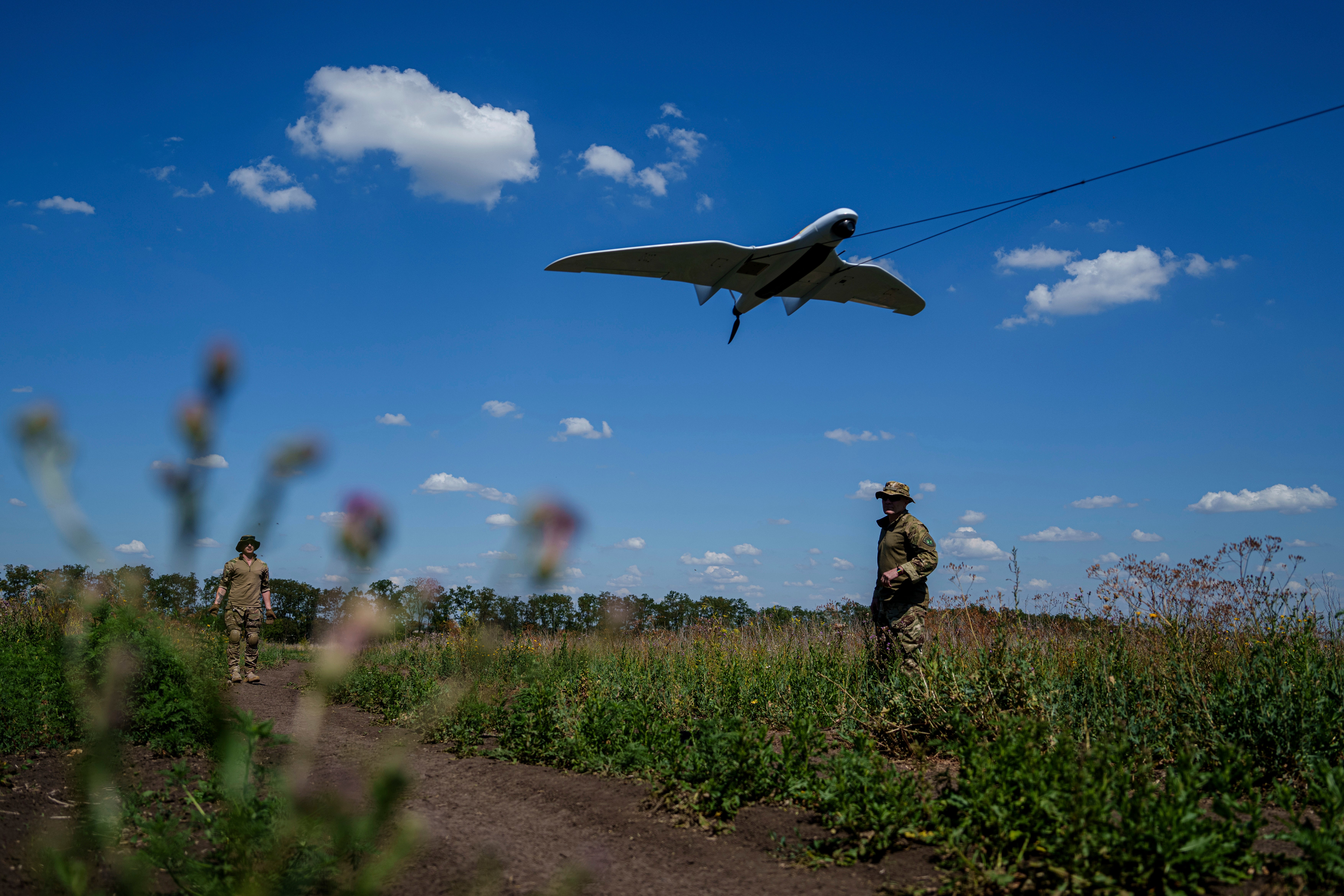 Ukrainian servicemen of the Ochi reconnaissance unit launch a Furia drone to fly over Russian positions at the frontline in Donetsk region