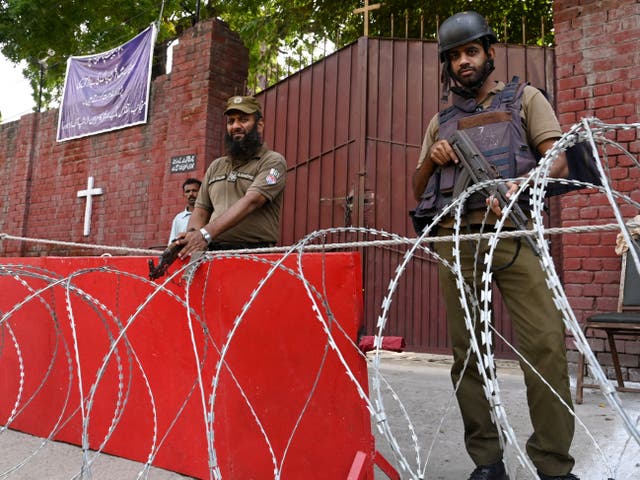 <p>Policemen stand guard outside a cathedral in Lahore on 20 August 2023</p>