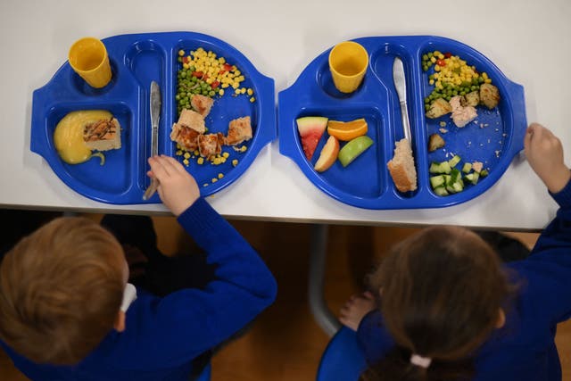<p>Children eat during lunch-break at St Mary’s RC Primary School, in Battersea, south London, on November 29, 2022</p>